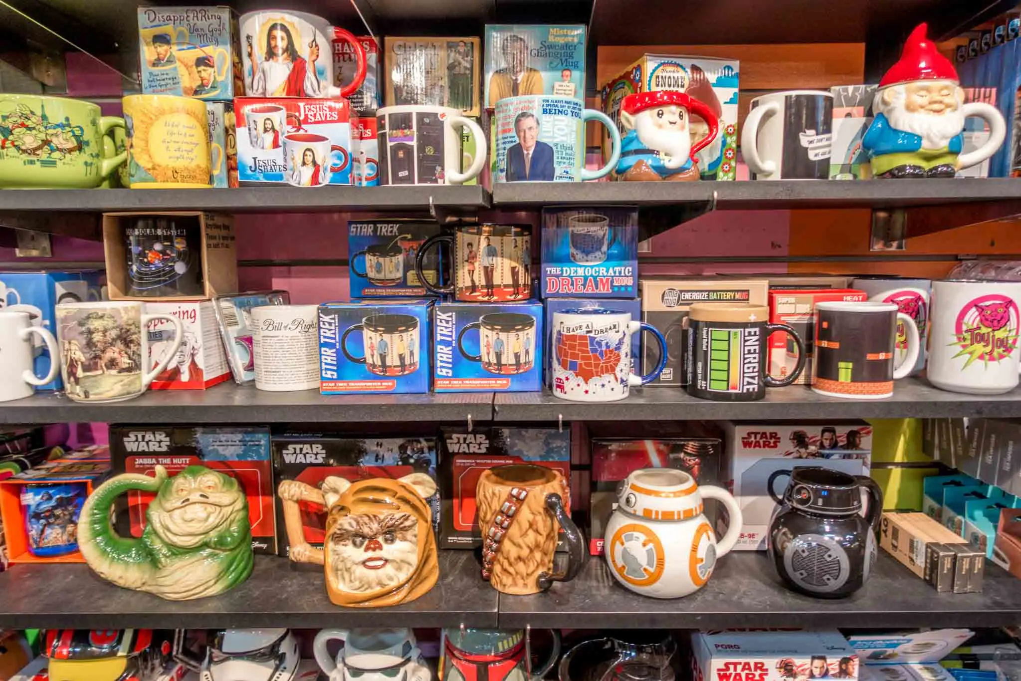 Star Wars-themed coffee mugs on a shelf 