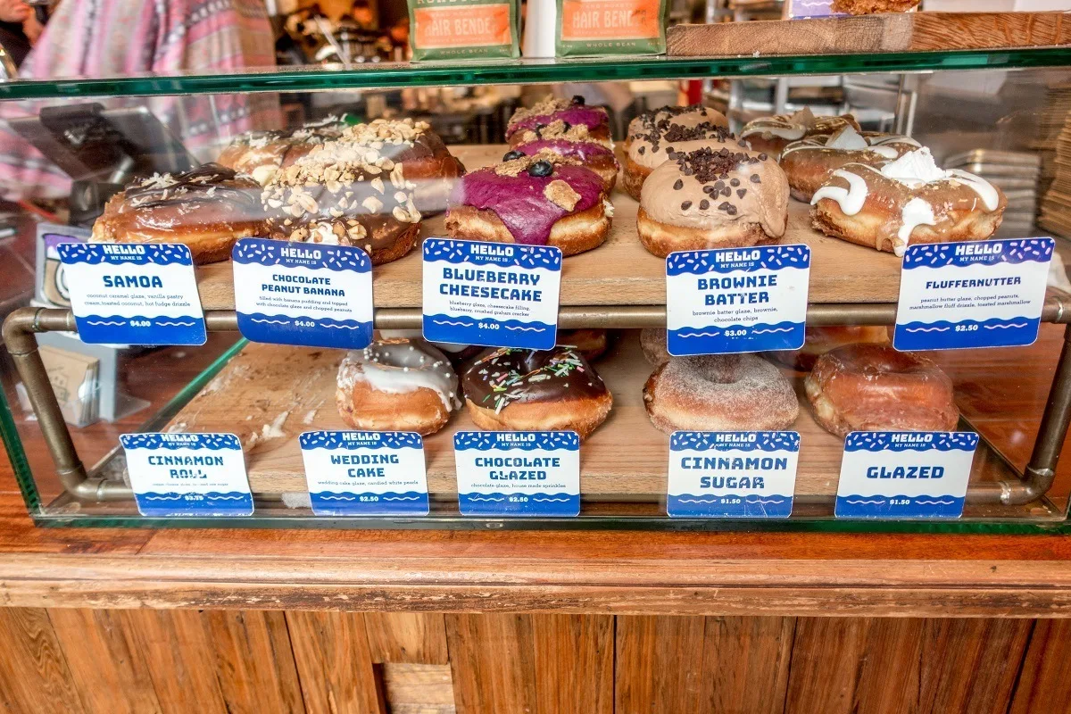 Unique flavors of donuts in display case. 