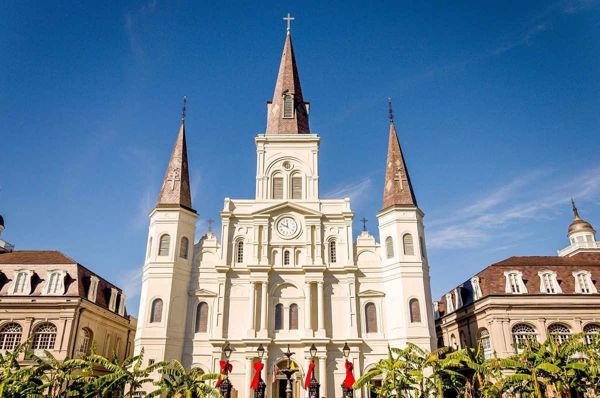 Exterior of a large white church with three spires.