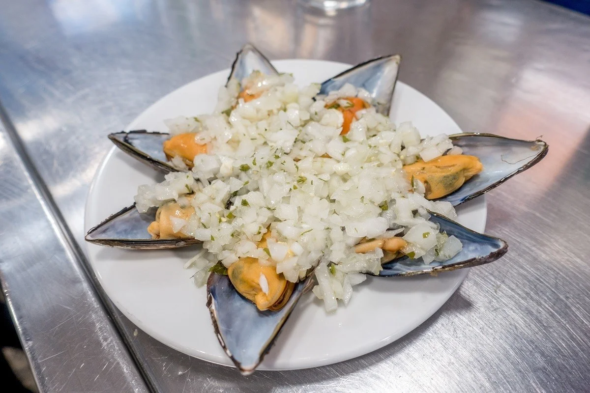 Fresh mussels topped with onions and vinaigrette