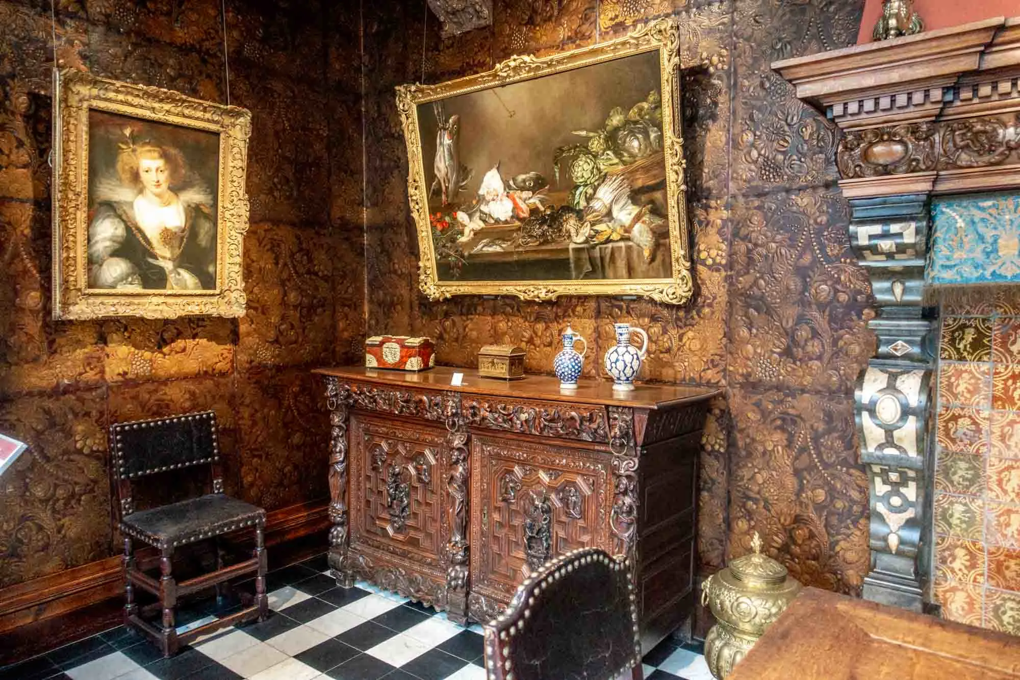 Ornate room with embossed leather wall coverings and Baroque paintings