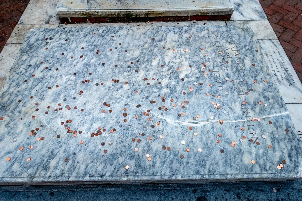 Benjamin Franklin's grave covered with pennies