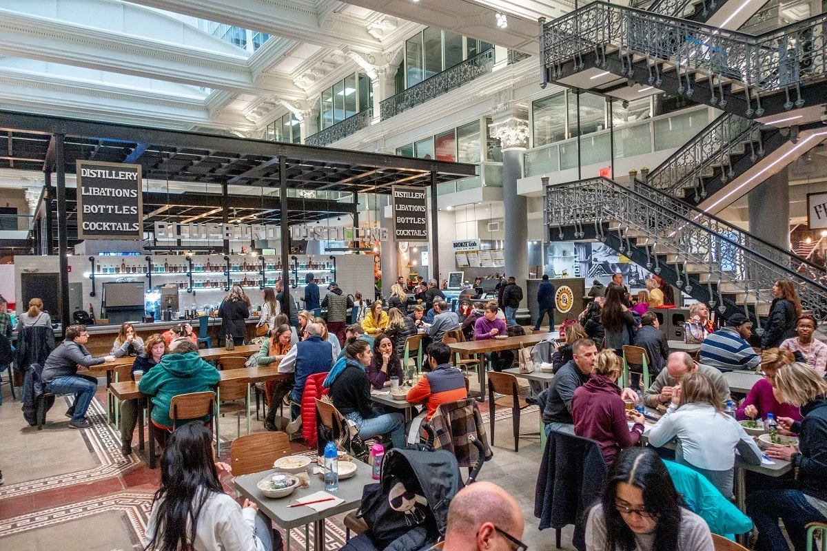 People eating at tables in a food hall