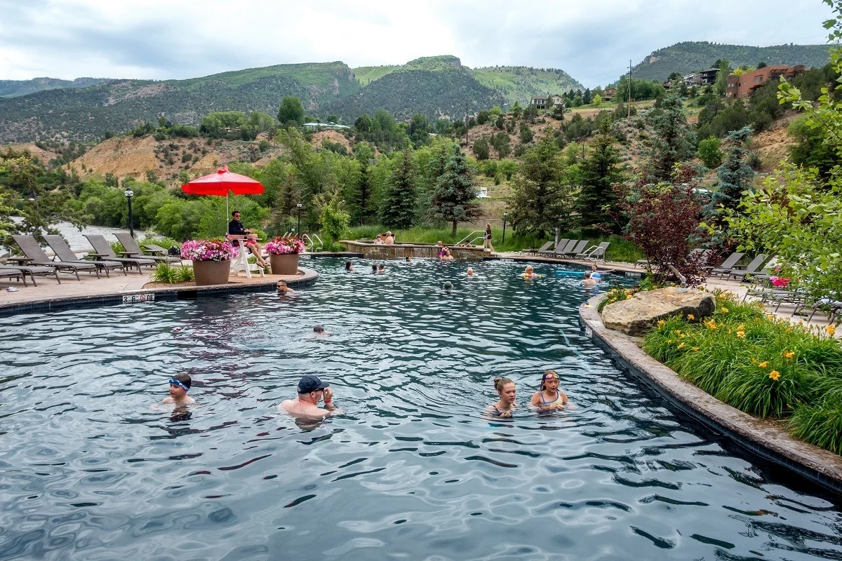 People swimming in a hot springs pool in the mountains
