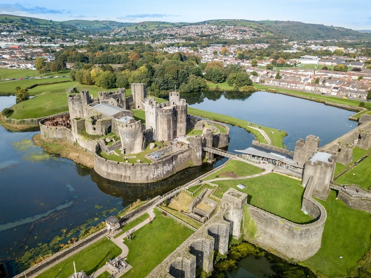 Aerial view of towers, bridge, and a moat at a castle