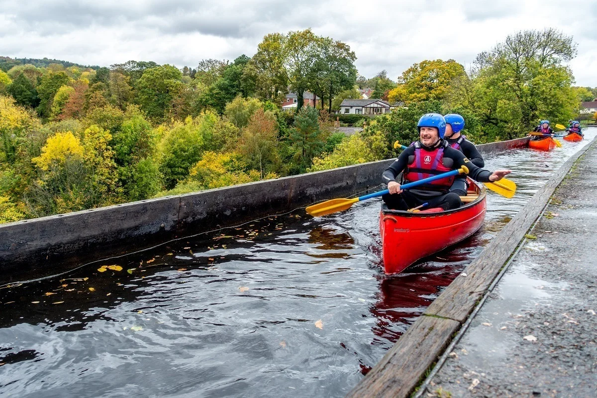 Kayakers paddling over an aqueduct