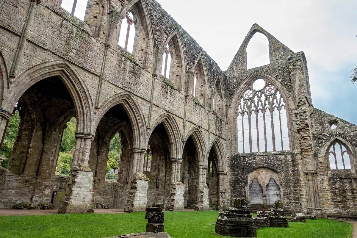 Ruins of a stone church with arches and intricate window frames