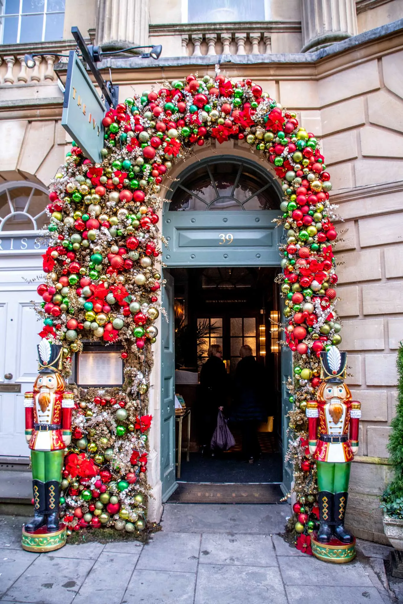 Doorway covered in ornaments and flanked by two nutcrackers