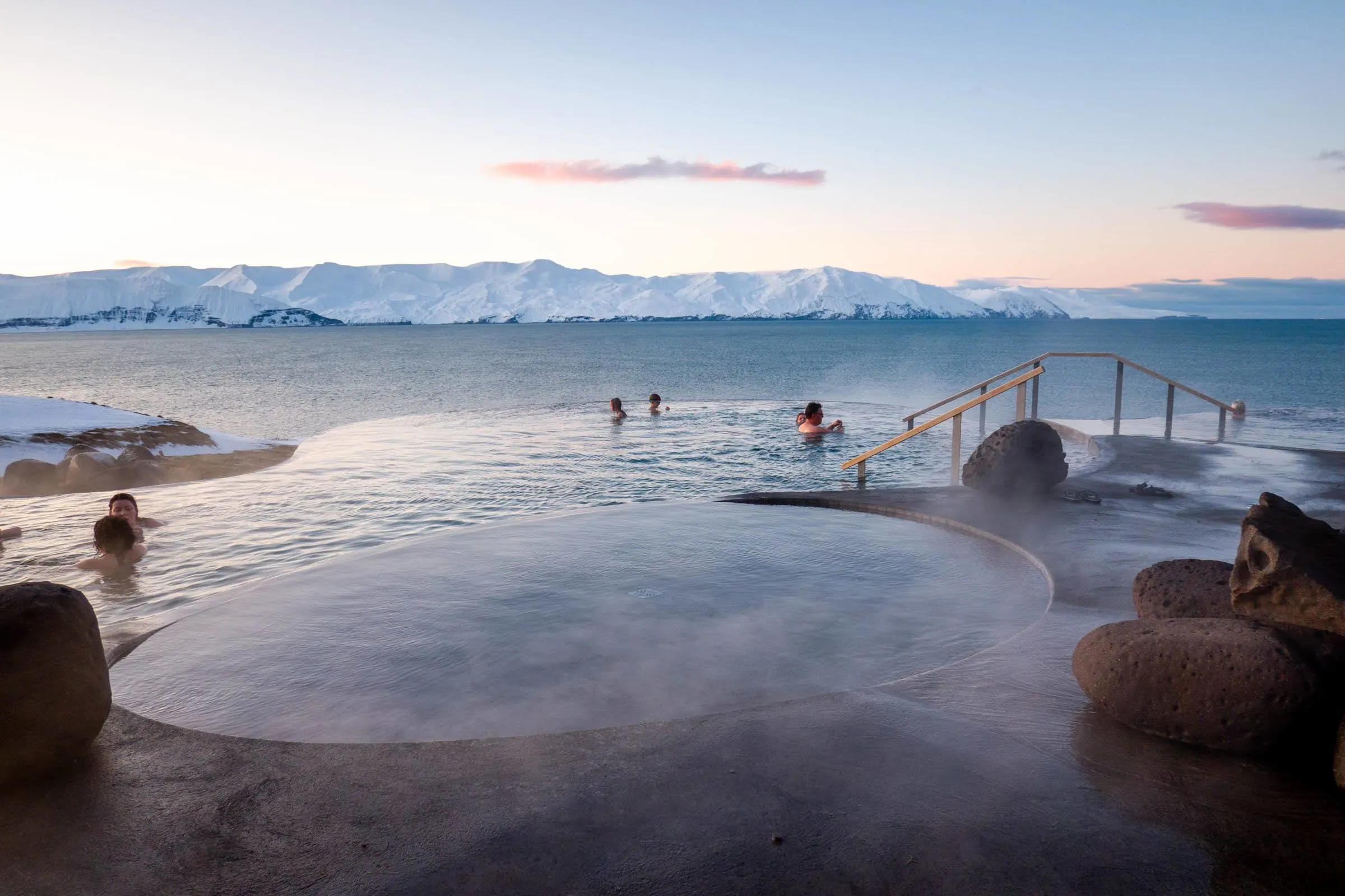 People in hot springs pools in the winter