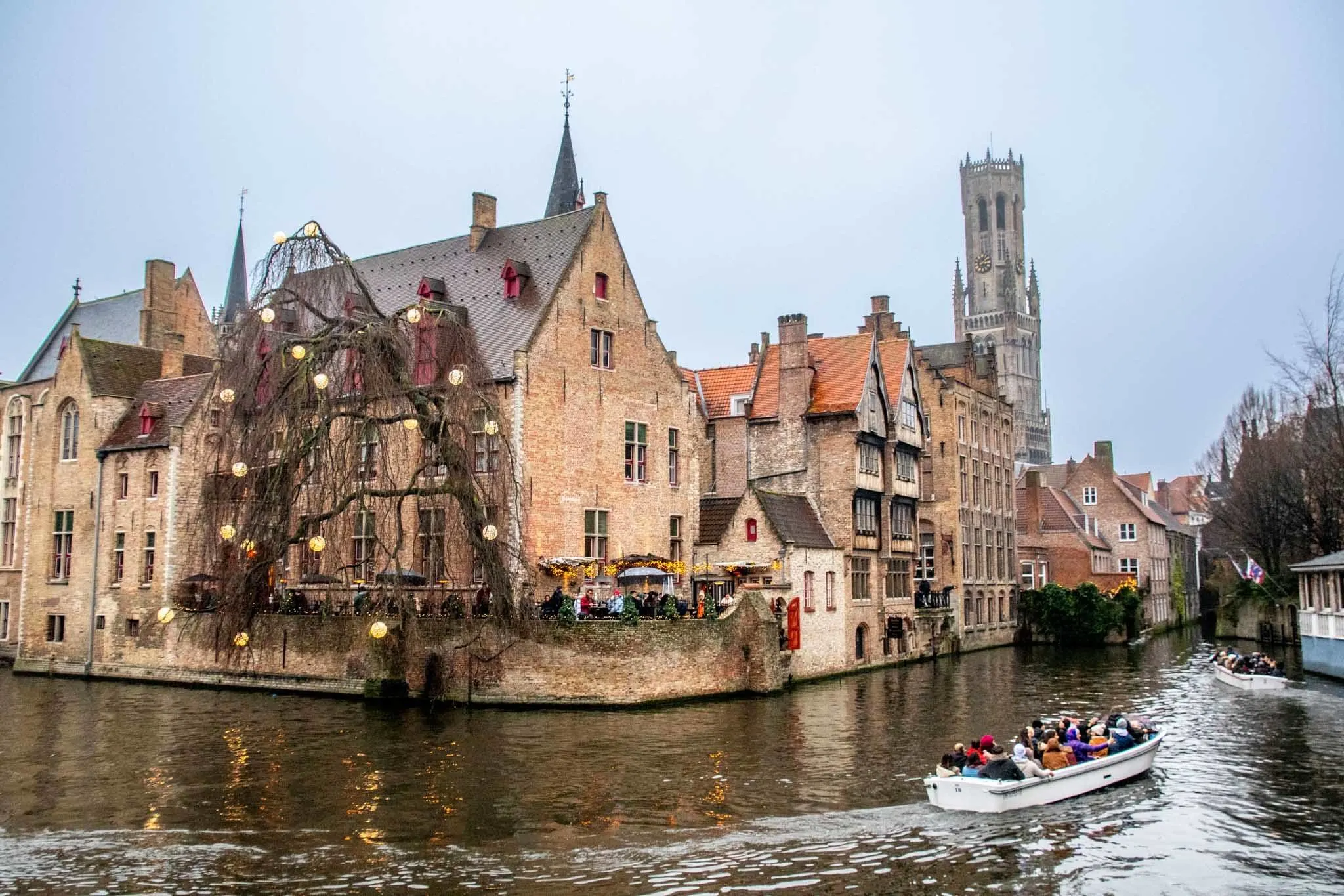 Two boats full of passengers in a canal 