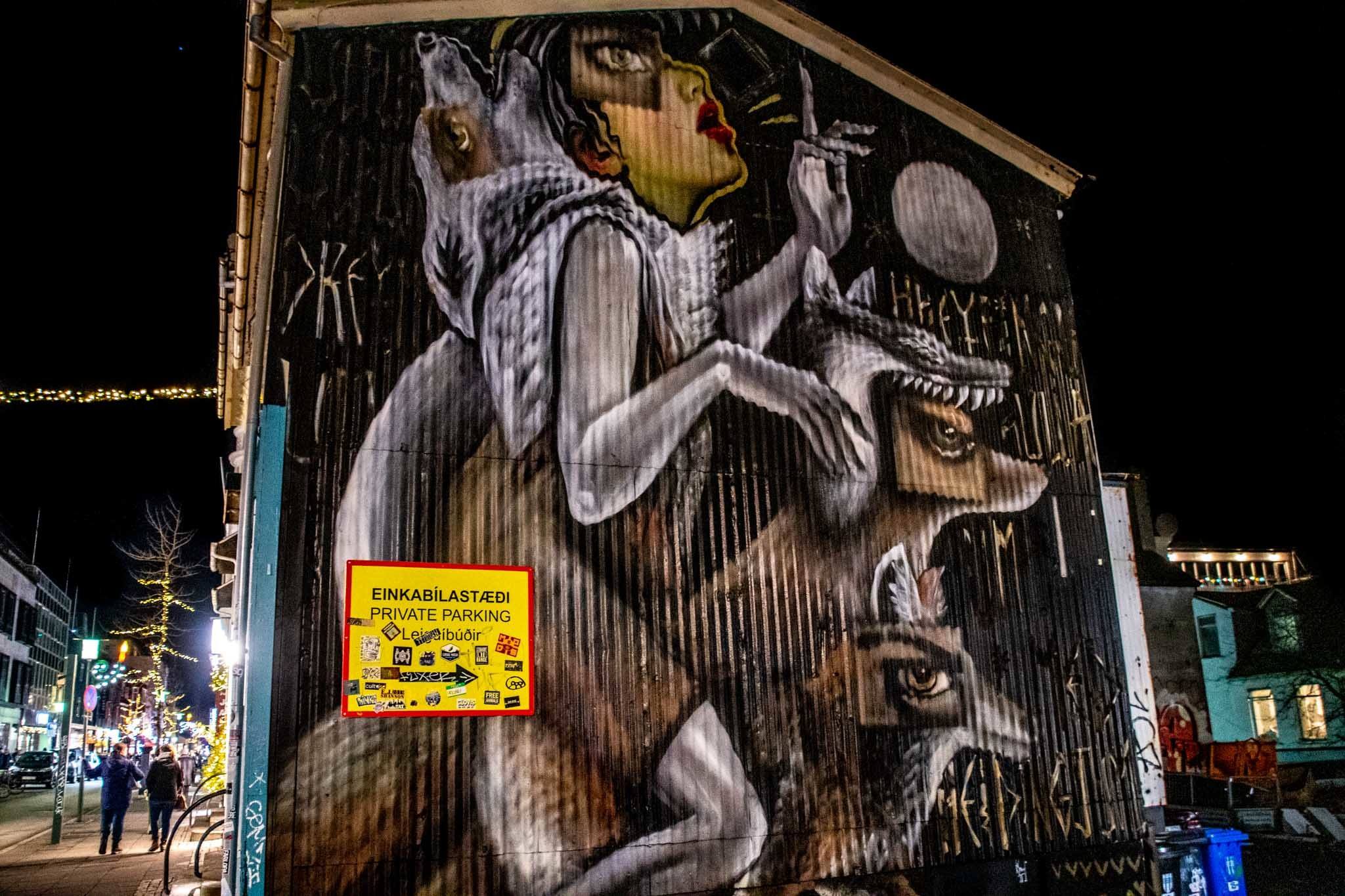 A street art mural featuring a woman and wolves.
