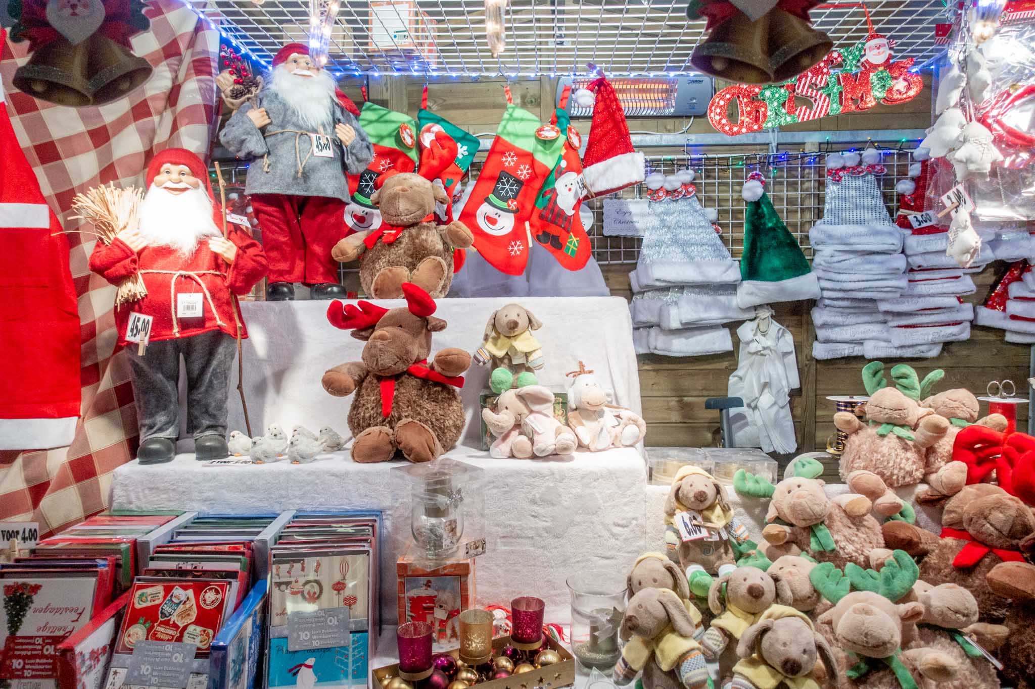 Stuffed animals, Santa hats, and other items for sale at the Bruges Xmas market