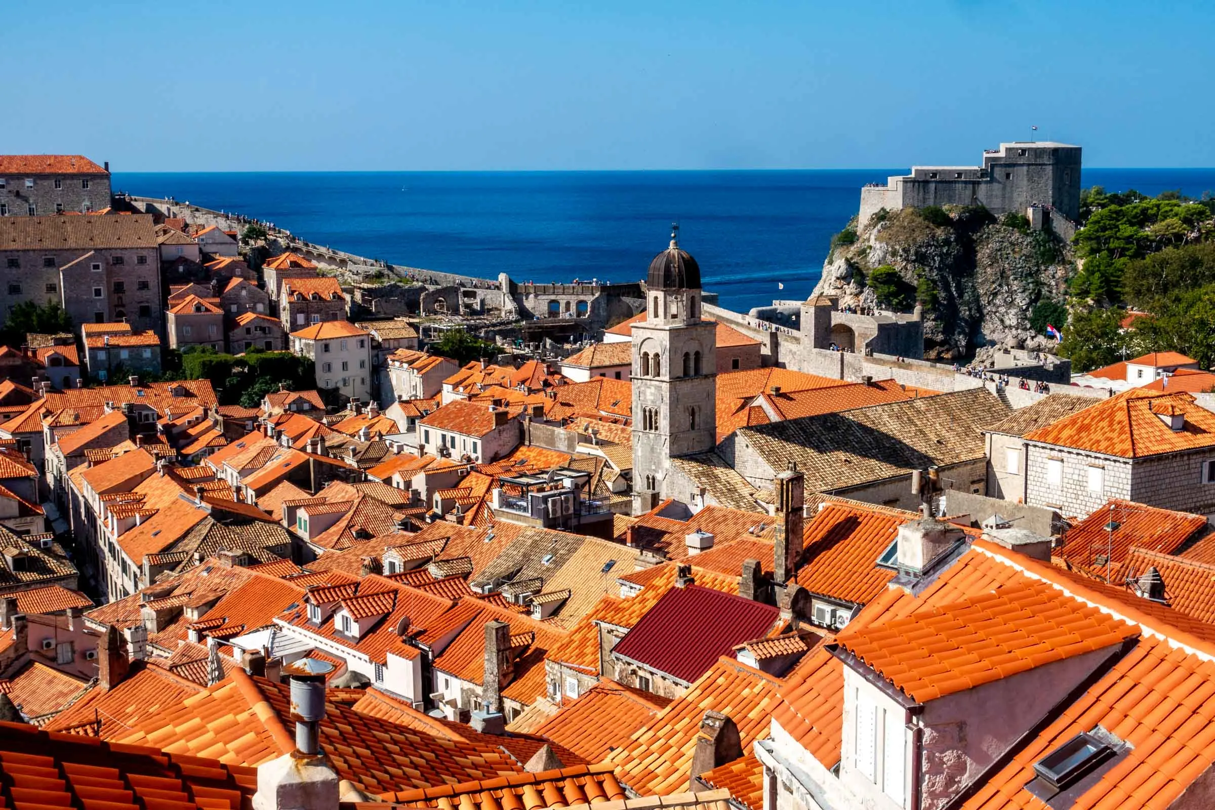 View of red roofs, bell tower, and ancient Dubrovnik city walls