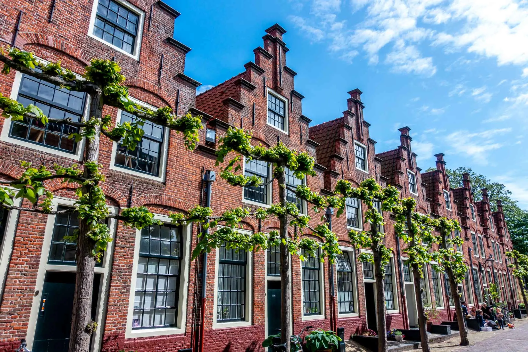 Row of red brick Dutch houses with step gabled roofs