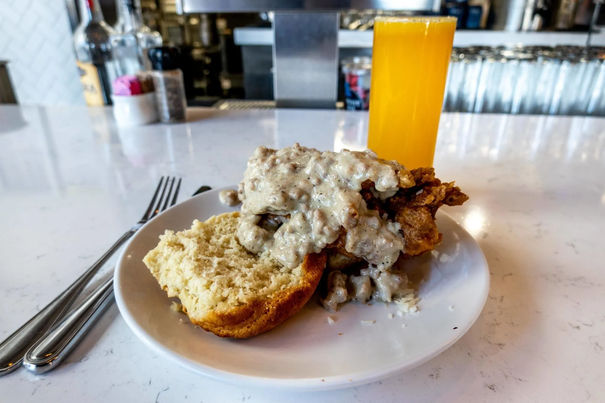 Orange juice and biscuit topped with chicken and gravy