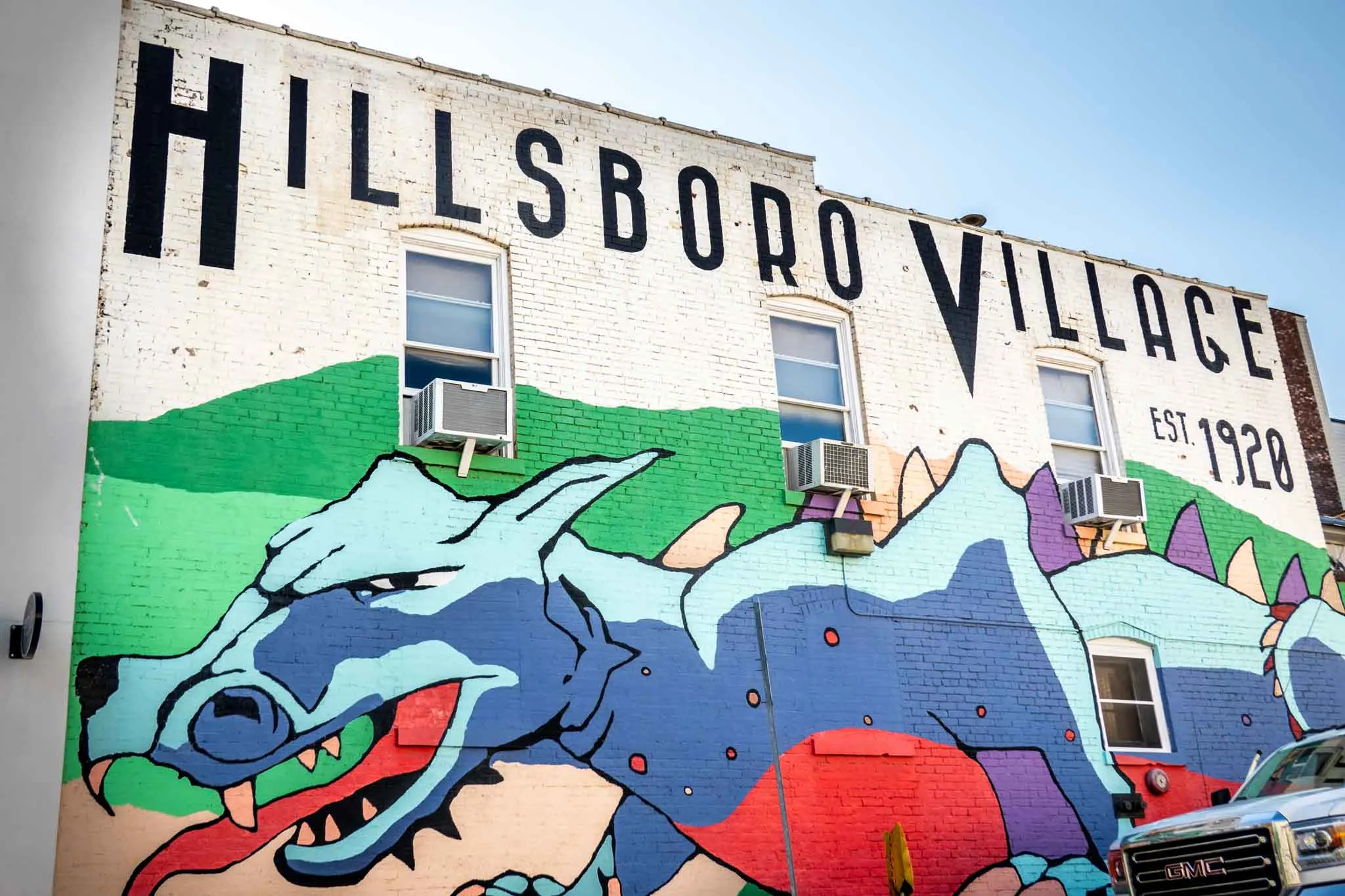 Mural of a multi-colored dragon labeled "Hillsboro Village, est. 1920."