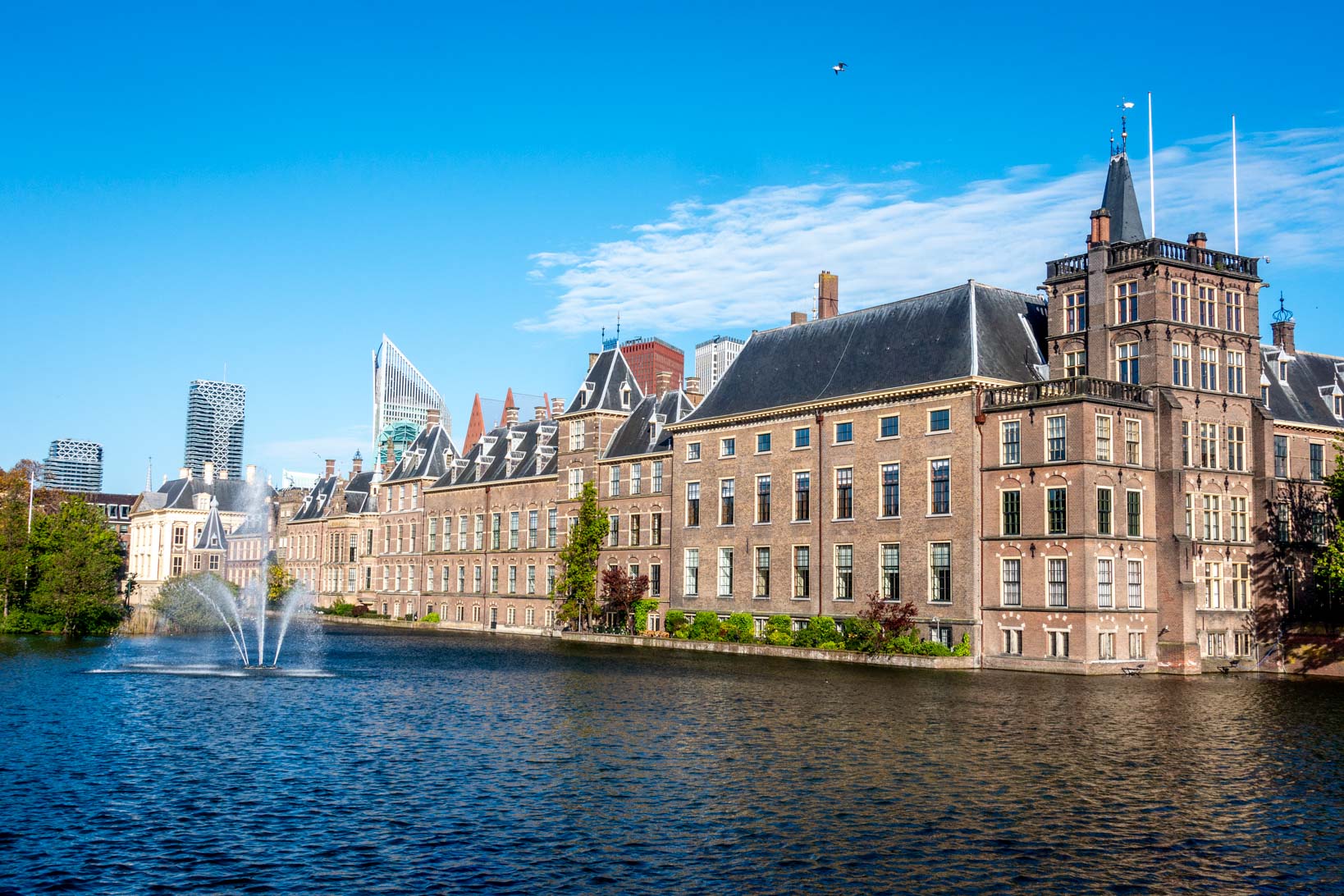 Large brick building beside a pond, the Binnenhof.