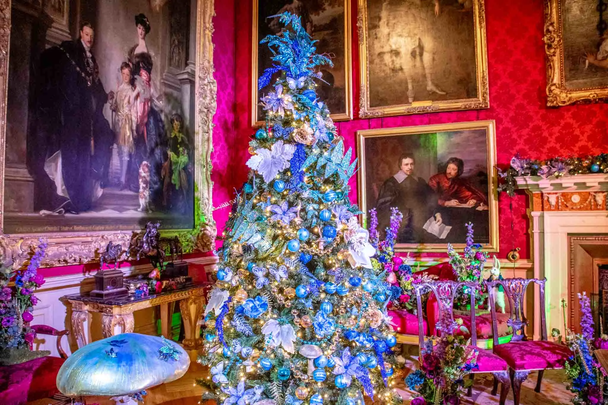 Decorated Christmas tree in a room filled with portraits