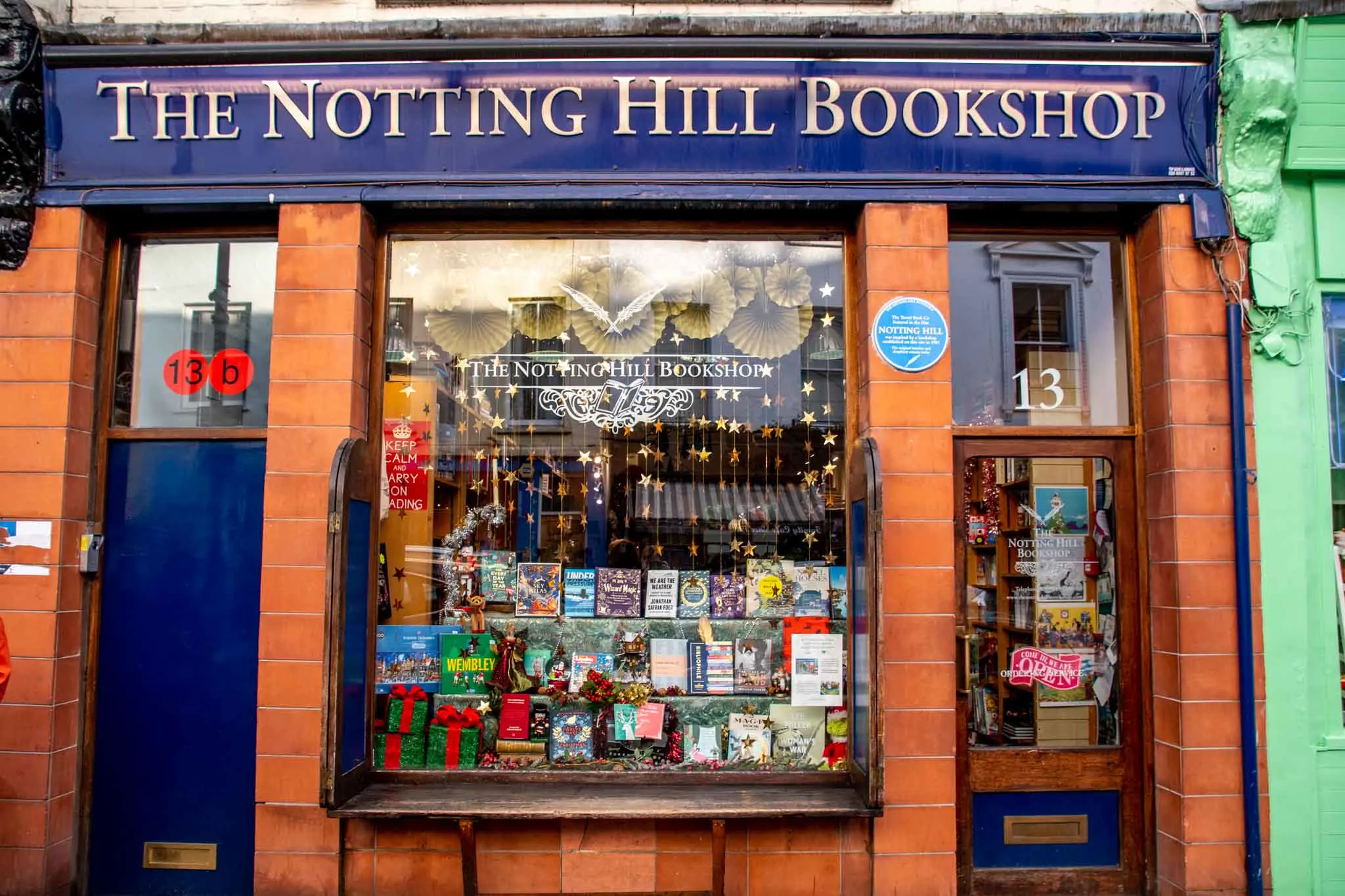 Brick exterior of Notting Hill Bookshop with a blue sign
