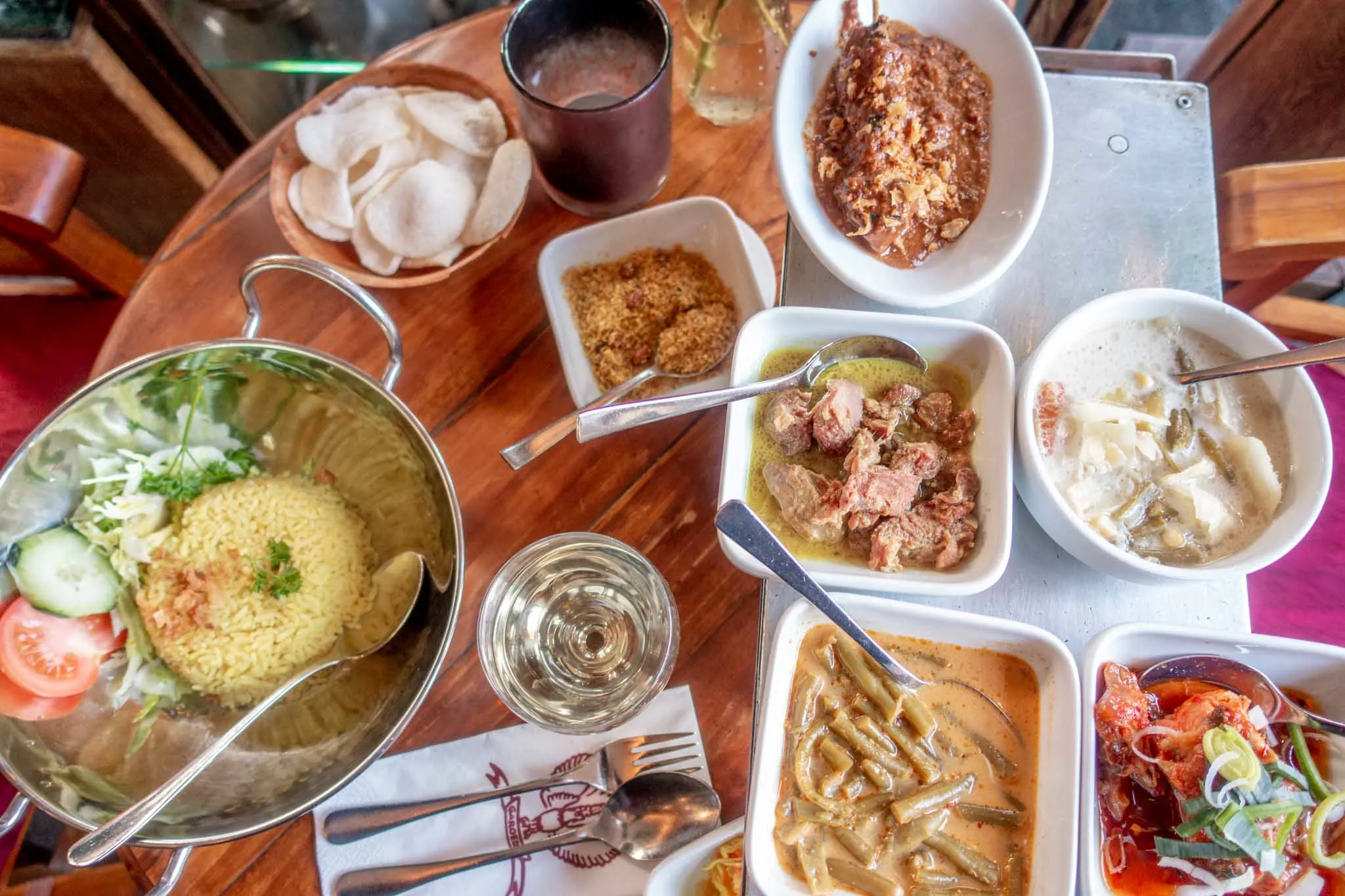 Lots of Indonesian food dishes in bowls on a table