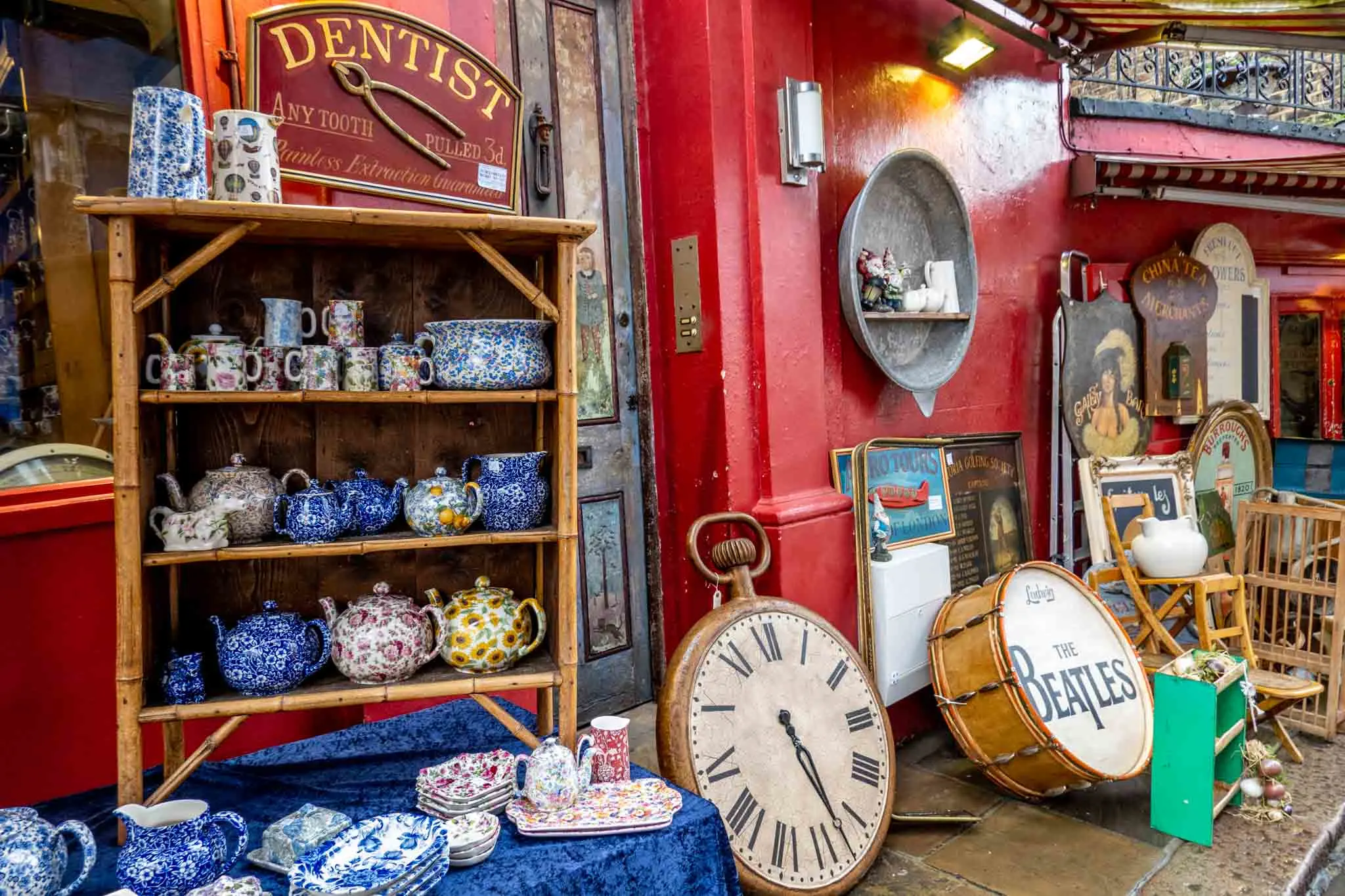 Teapots, ceramics, and other items displayed outside antique shop