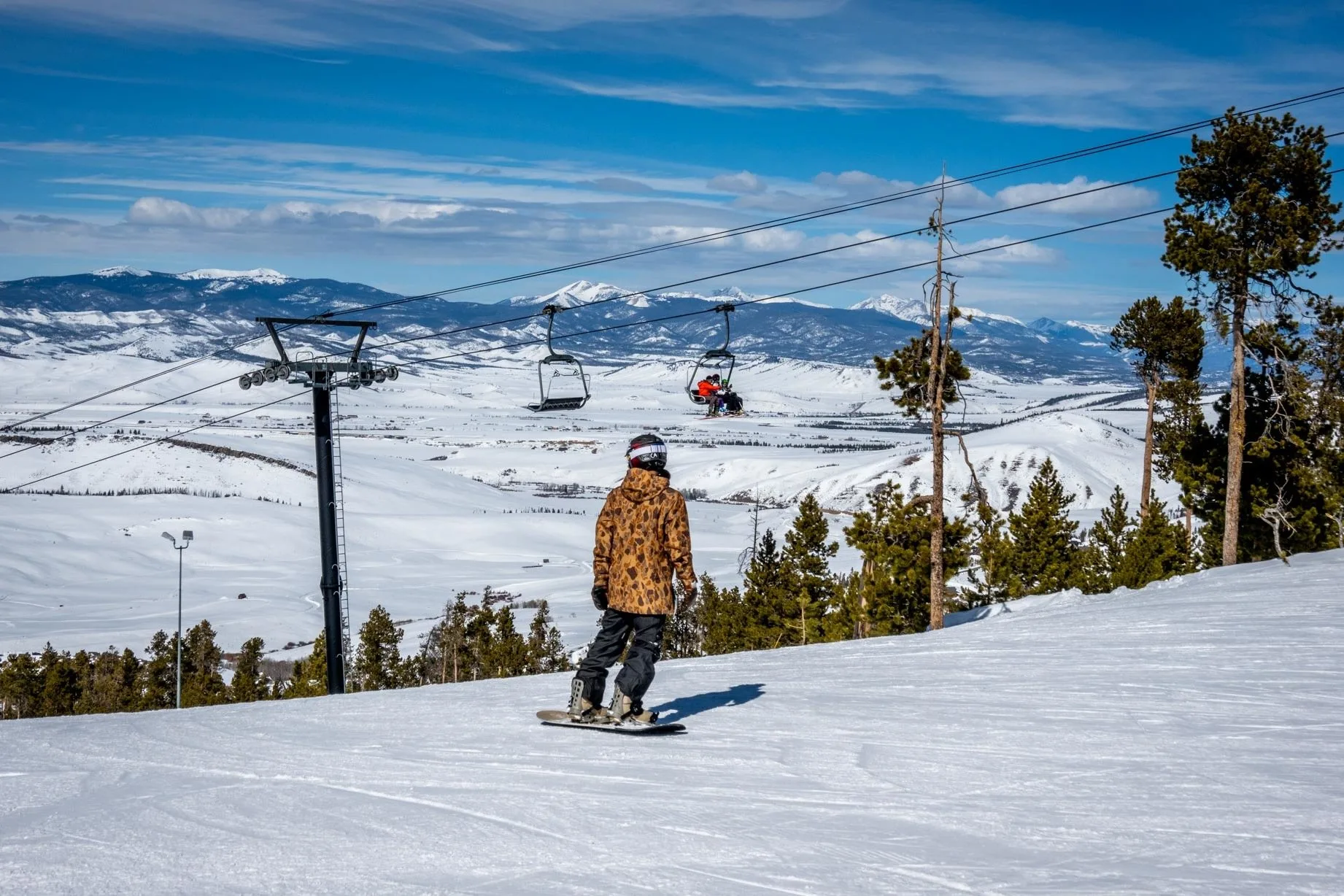 Snowboarder on a mountain near a ski lift