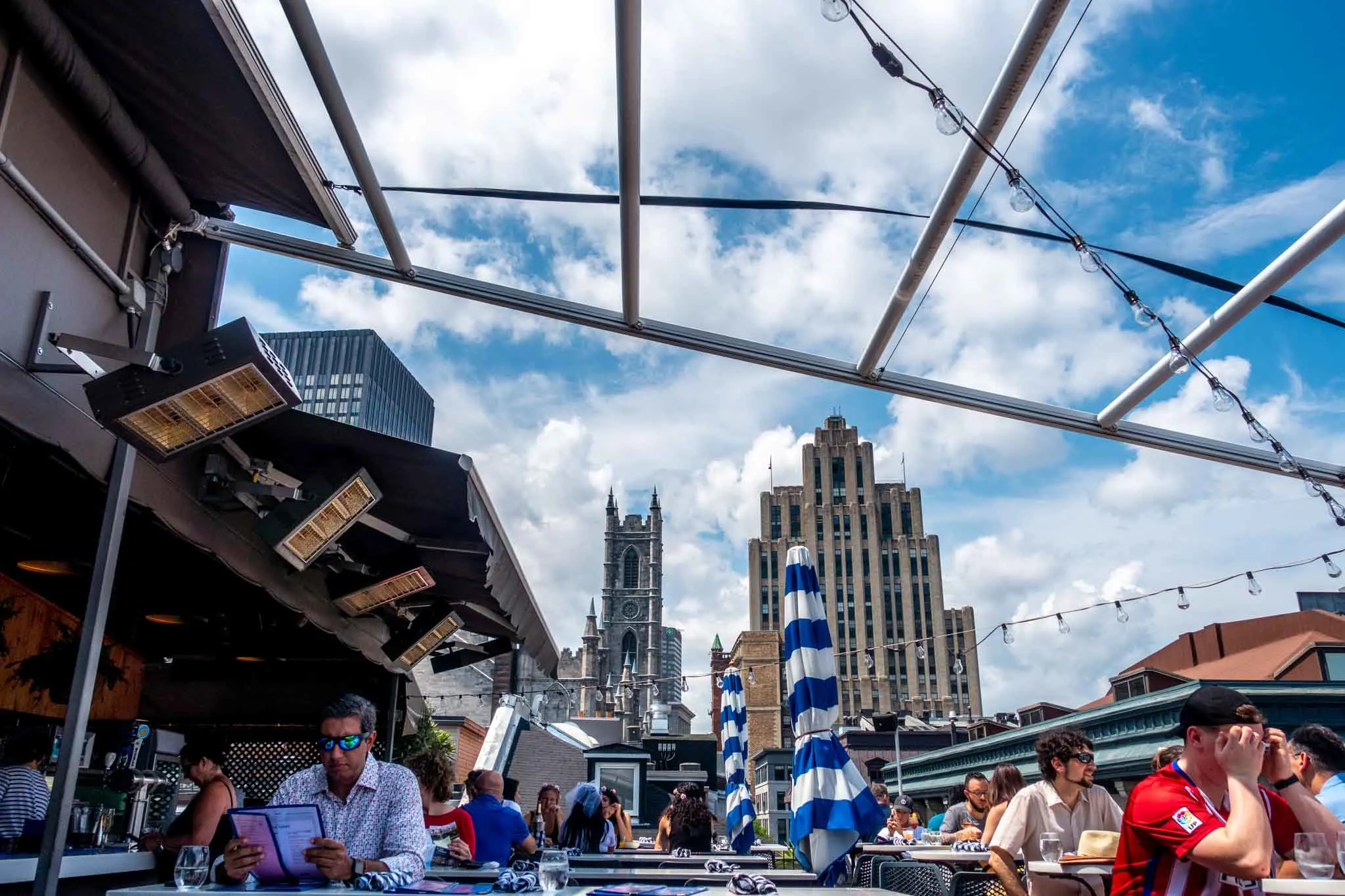 People at a rooftop bar with skyline views