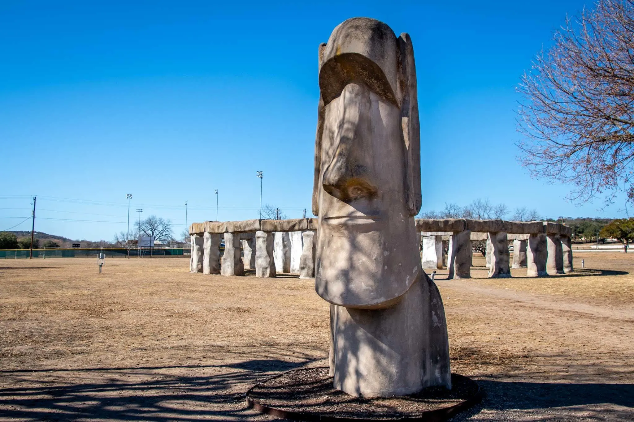 13-foot-tall stone head in front of a replica of Stonehenge
