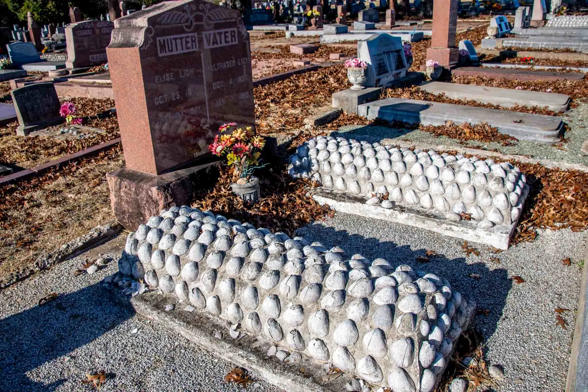 Two graves covered in scallop seashells