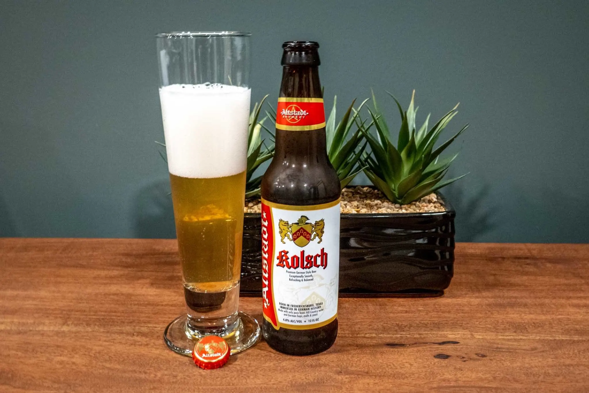 Glass and bottle of Kolsch beer on table