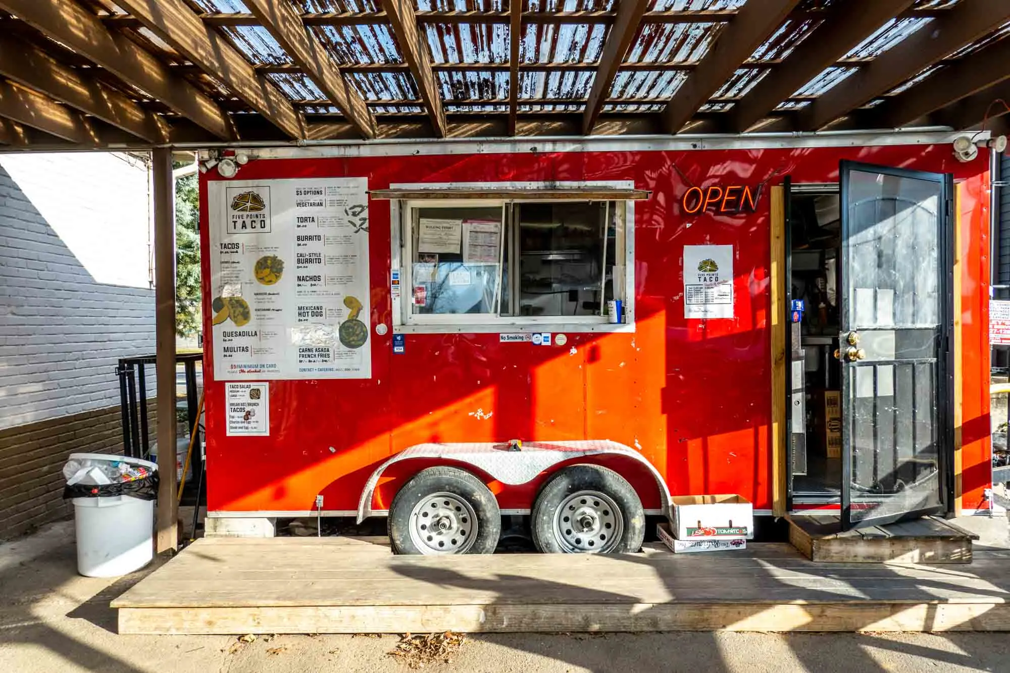 Red food truck with a menu on its side