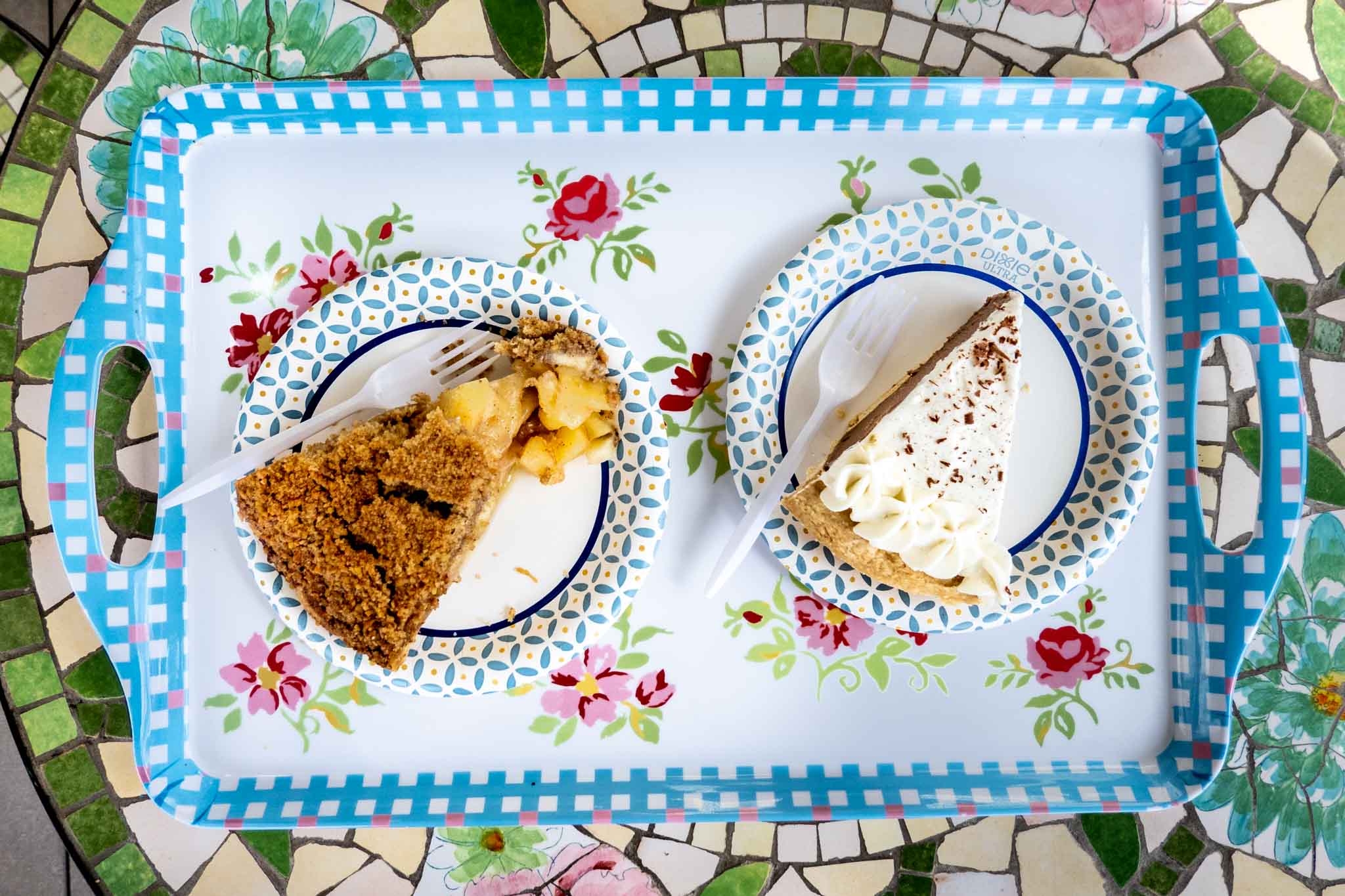 Two slices of pie on a colorful tray.