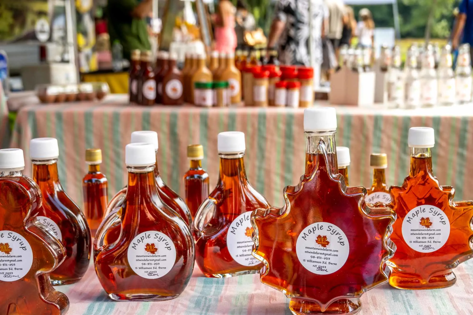 Bottles of maple syrup on a table.