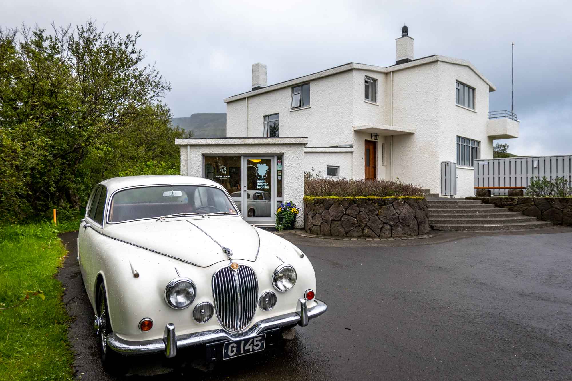 White Jaguar car in front of home of Halldor Laxness on the Golden Circle