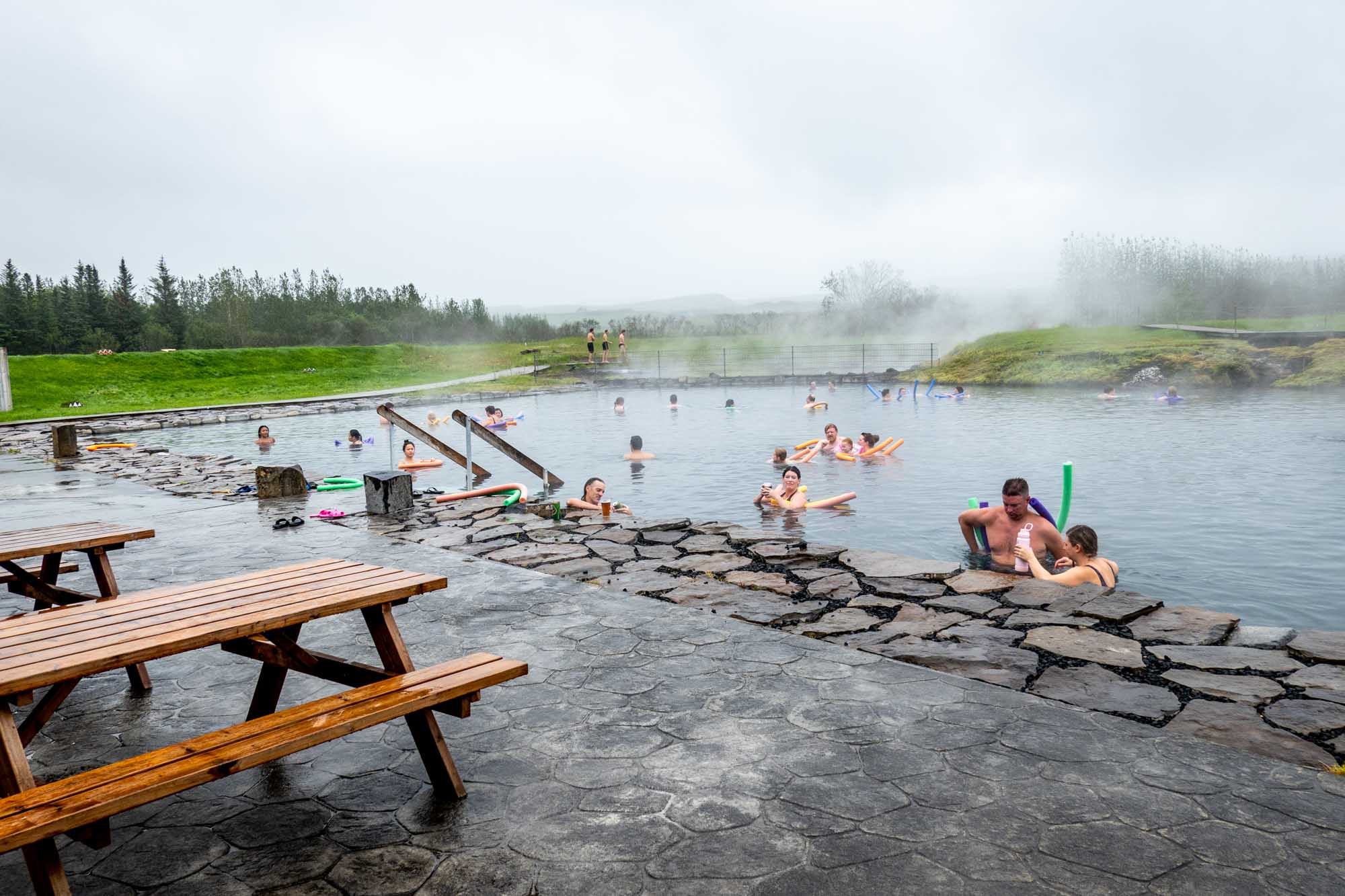 People in swimming in hot springs pool in Iceland