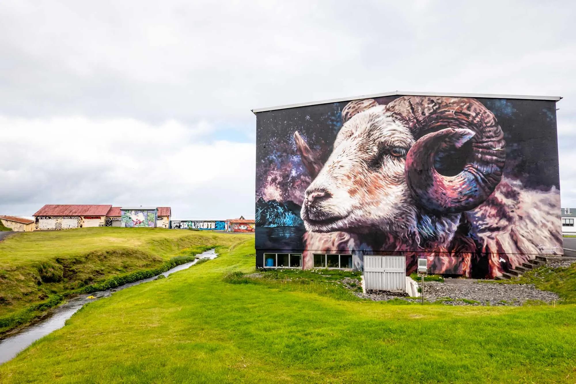 Mural of a ram with horns on side of a building