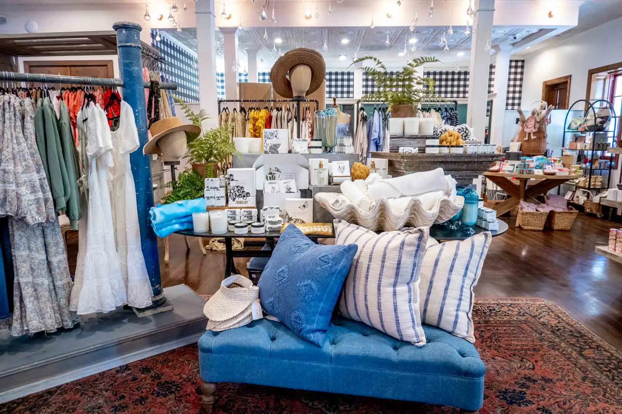 Dresses, pillows, and homegoods for sale in a boutique.