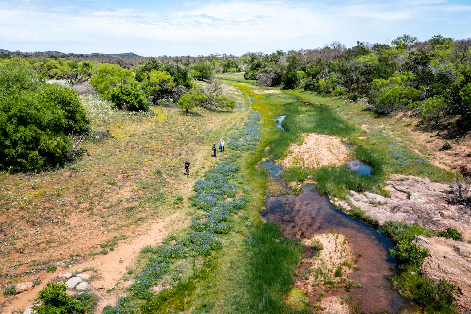 People walking in a nearly dry streambed