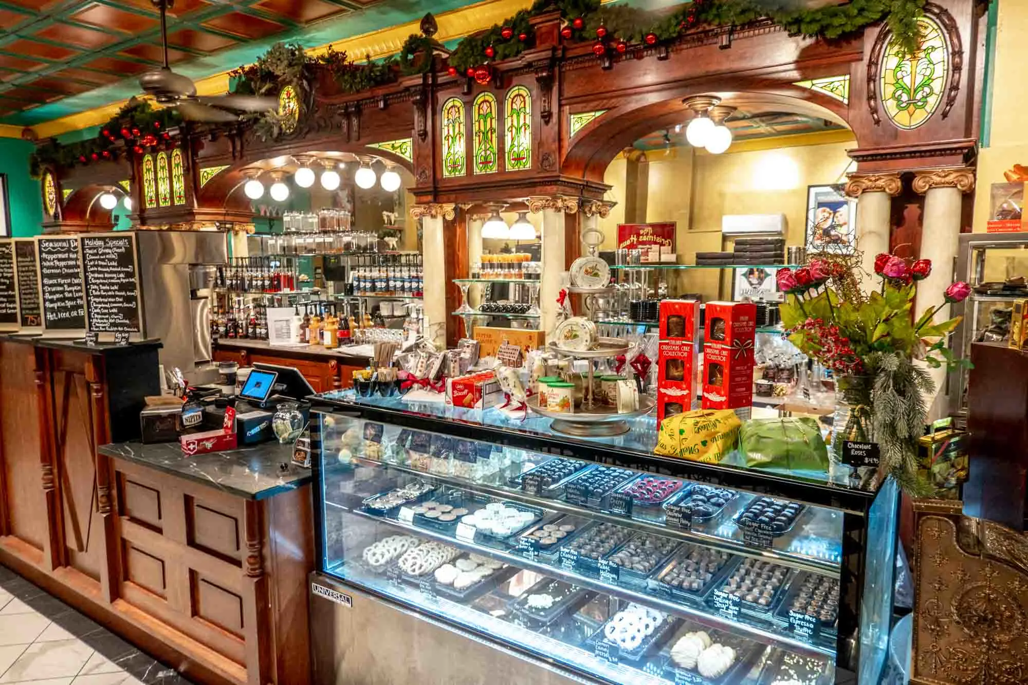 Wooden bar with inlaid stained glass panels and a display case for chocolates.