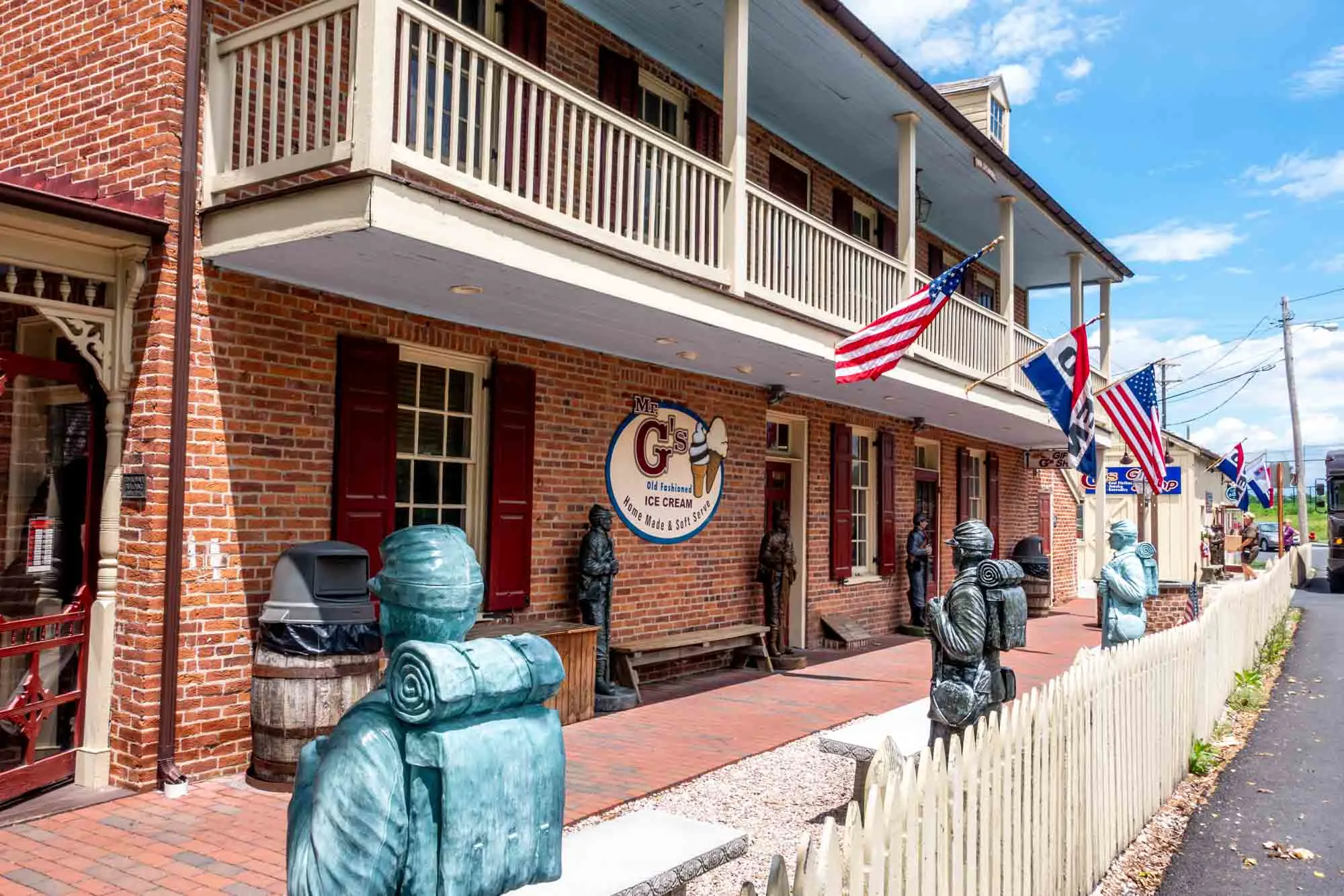 Red brick building flying American flags with a sign for "Mr. G's Old Fashioned Ice Cream"