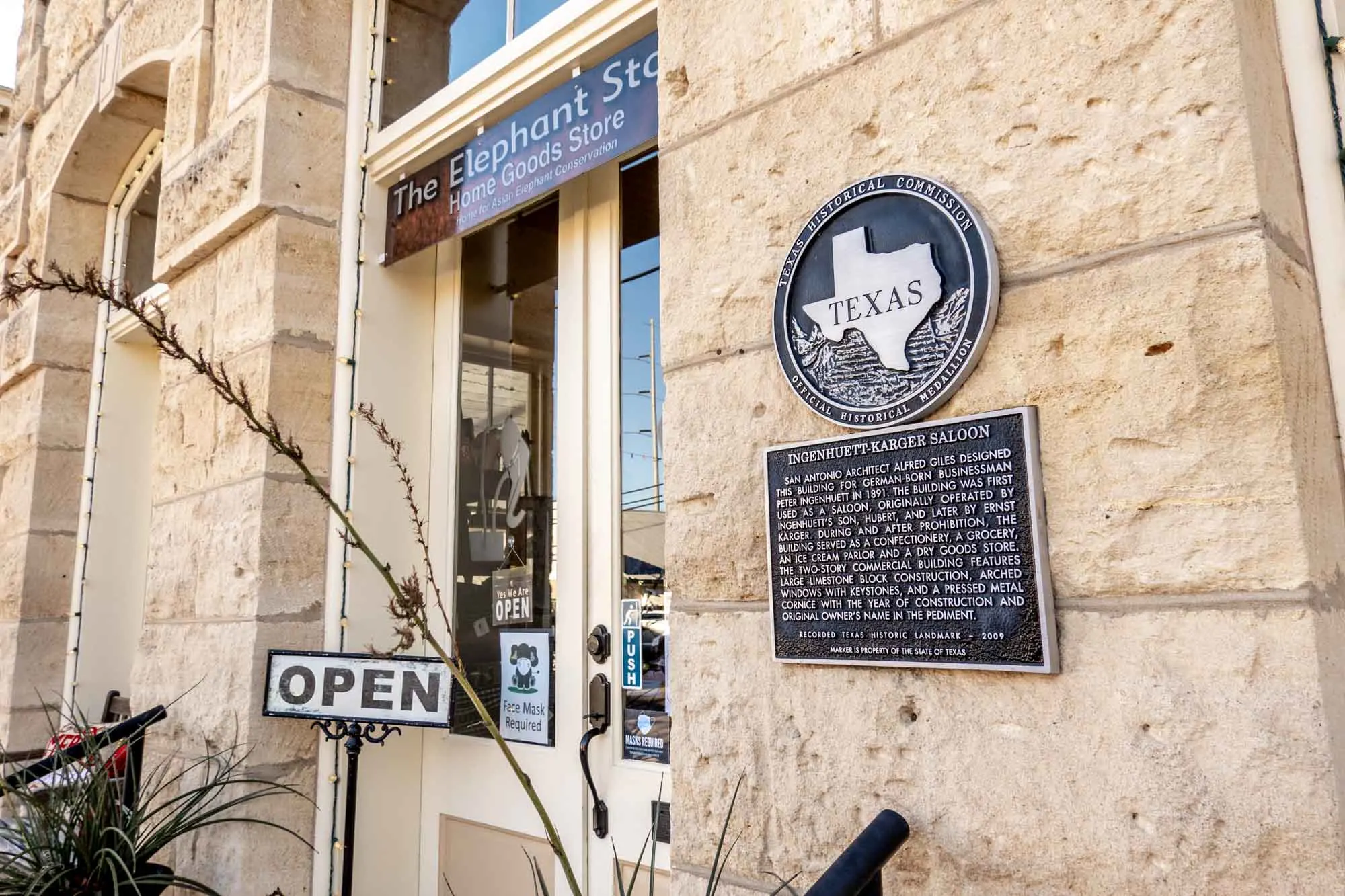 Exterior of a stone building with a Texas historical marker