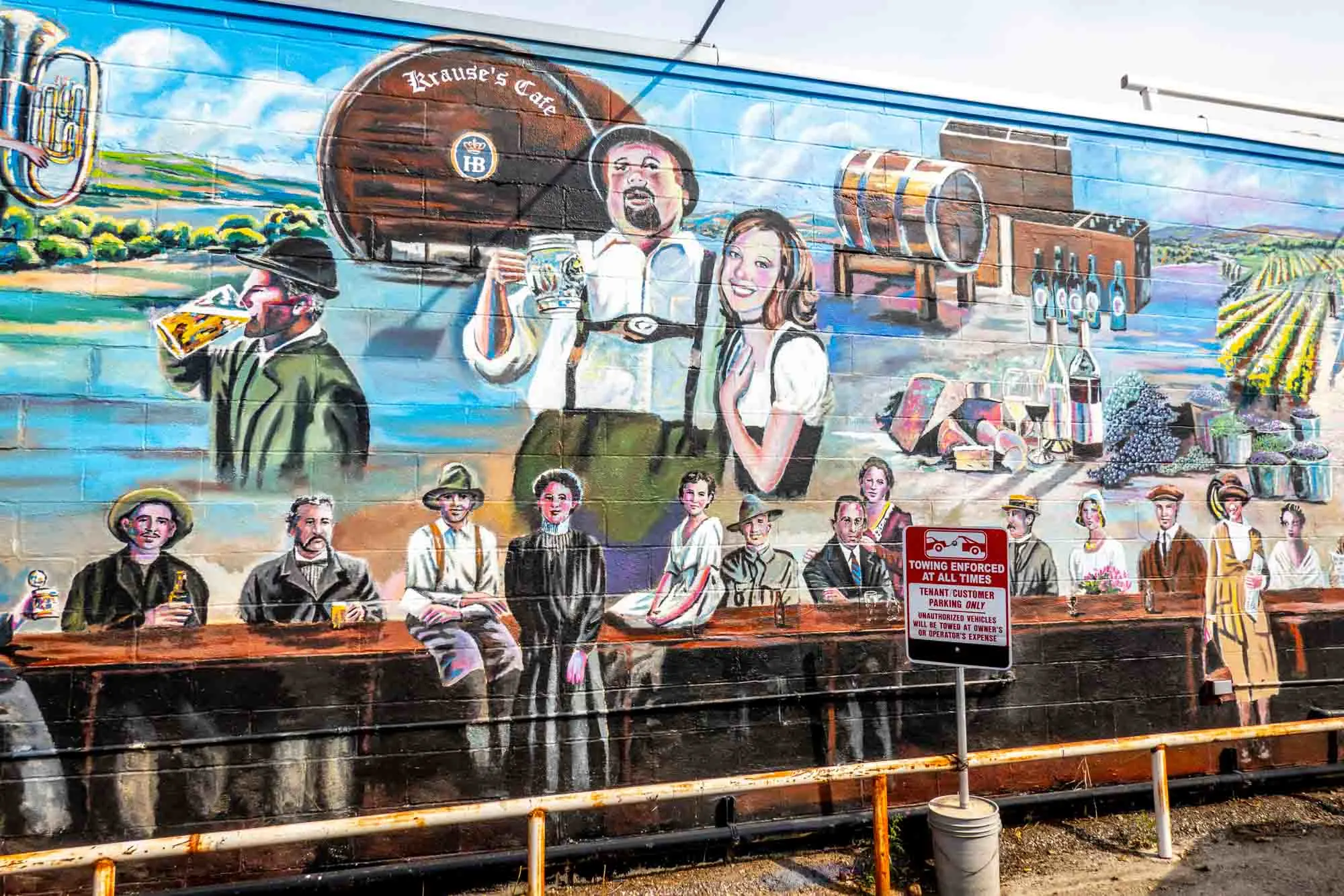 Mural showing people in classic German clothing and a beer barrel labeled "Krause's Cafe"
