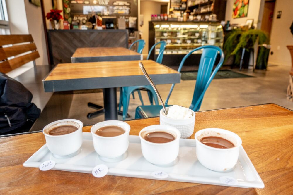 Tasting flight of drinking chocolate on a cafe table.