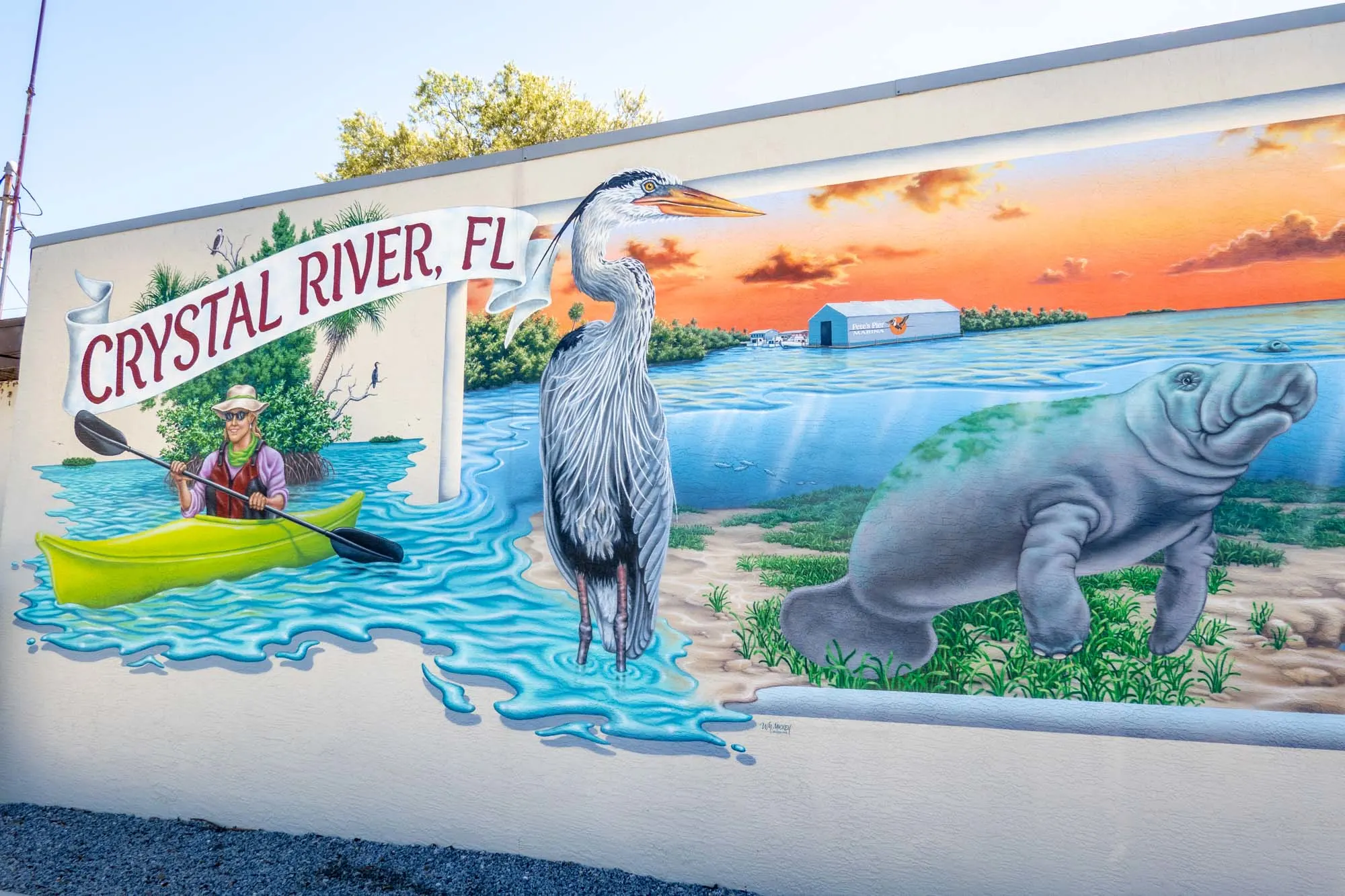 Mural with manatee, bird and sea kayaker that says "Crystal River, FL"