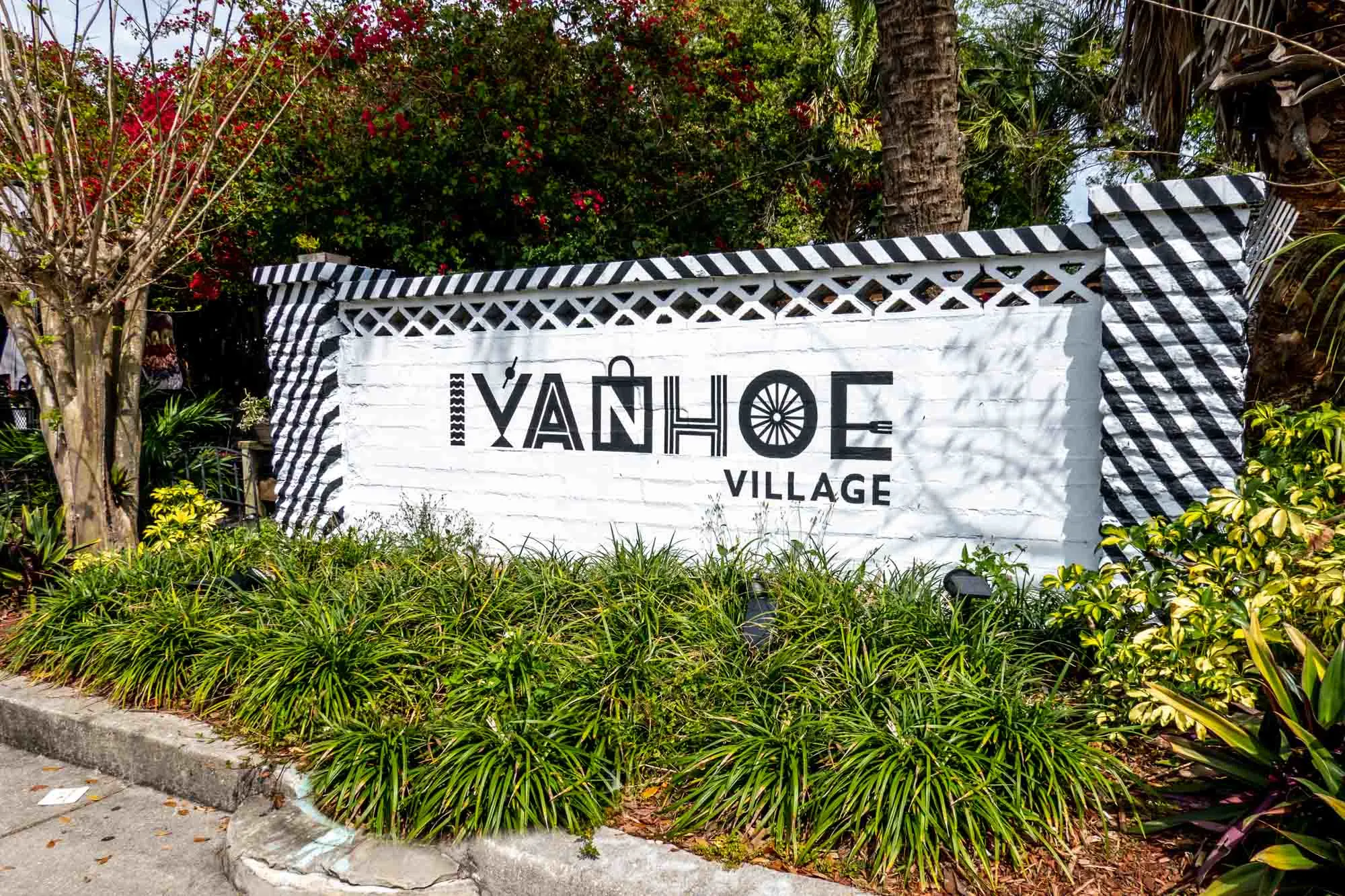 Black and white brick wall painted with a sign for "Ivanhoe Village."