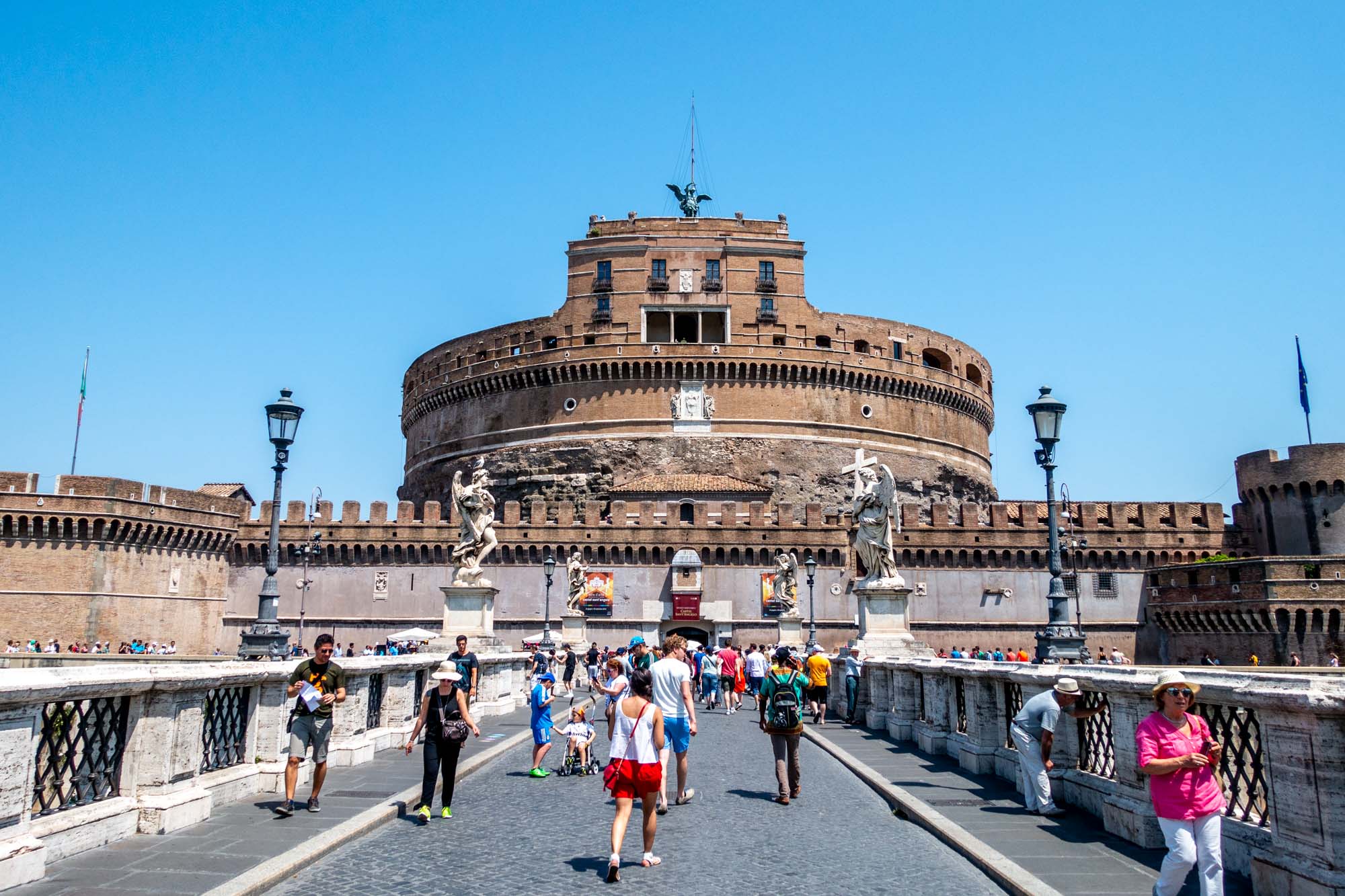 People in front of the circular Castel Sant'Angelo in Rome