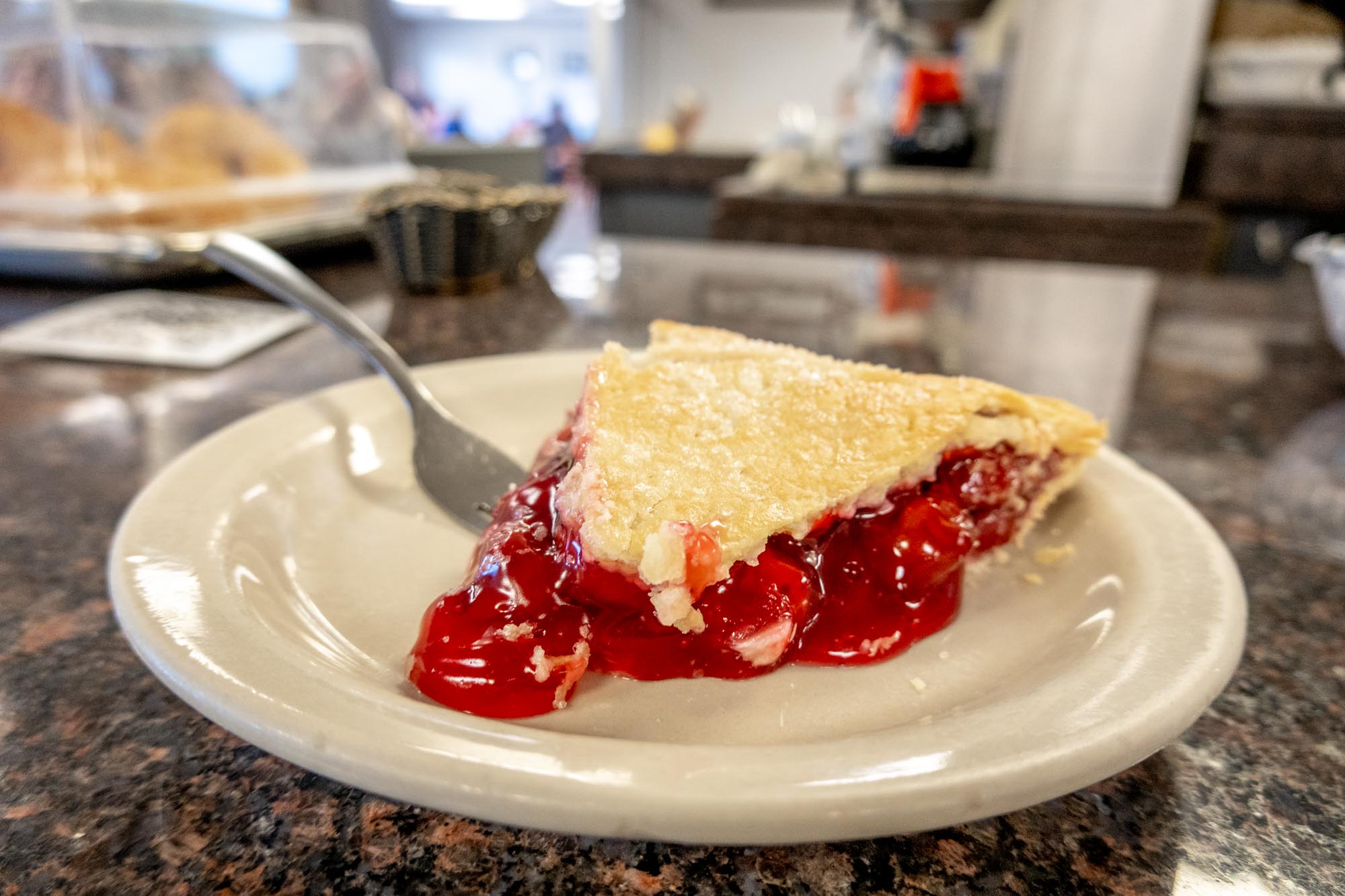Slice of cherry pie on a plate.