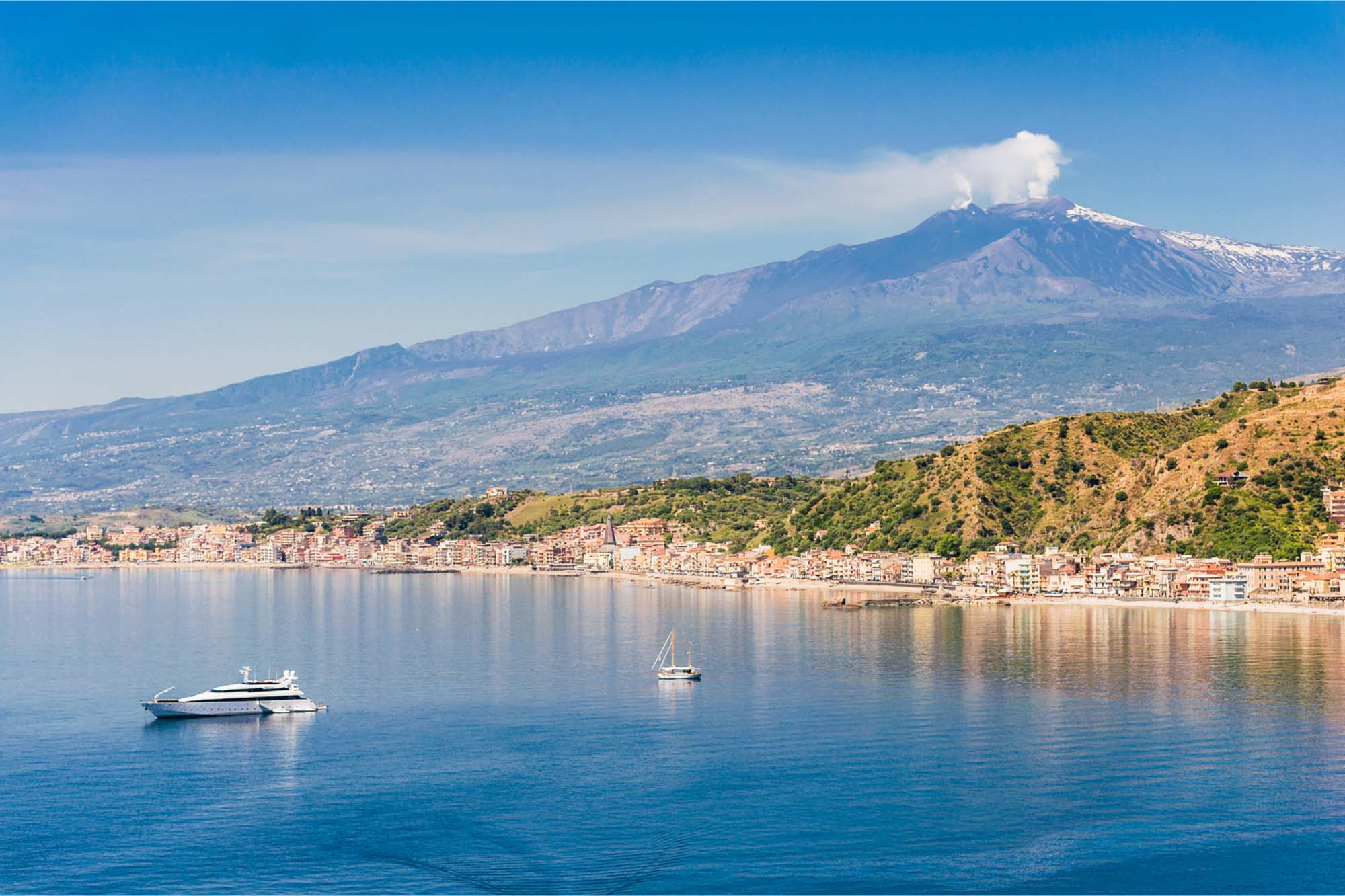 Mount Etna towering near the coast and ocean