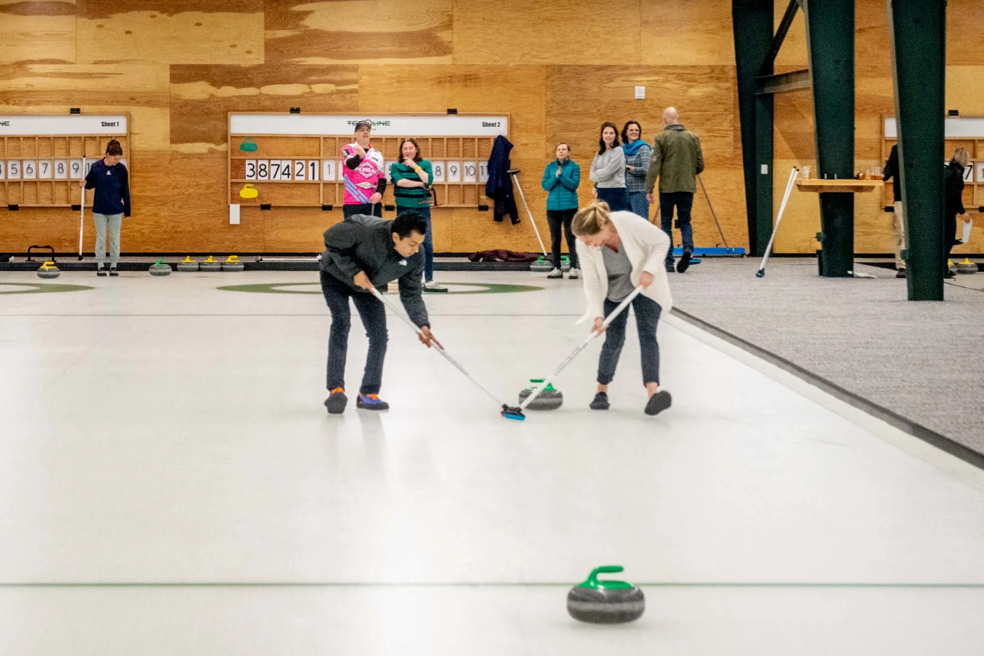 People curling on an ice rink