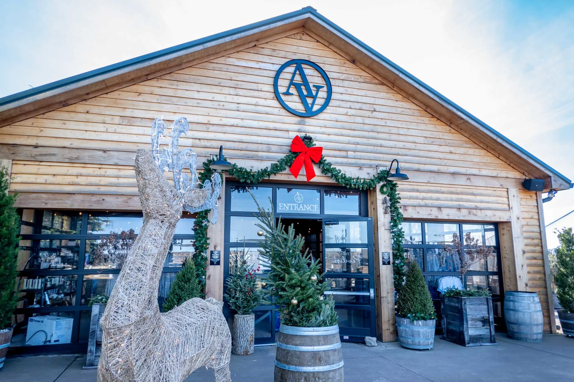 Reindeer decorations and holiday garland outside a winery tasting room.